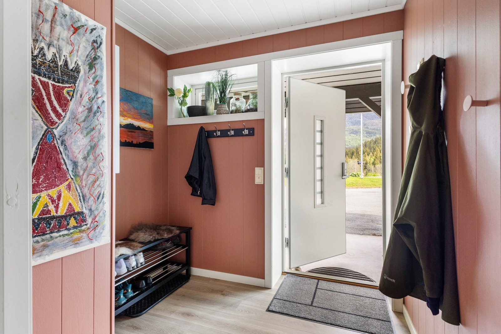 Entréen gir et hyggelig førsteinntrykk med lyse overflater og plass til garderobeløsning Galleribilde