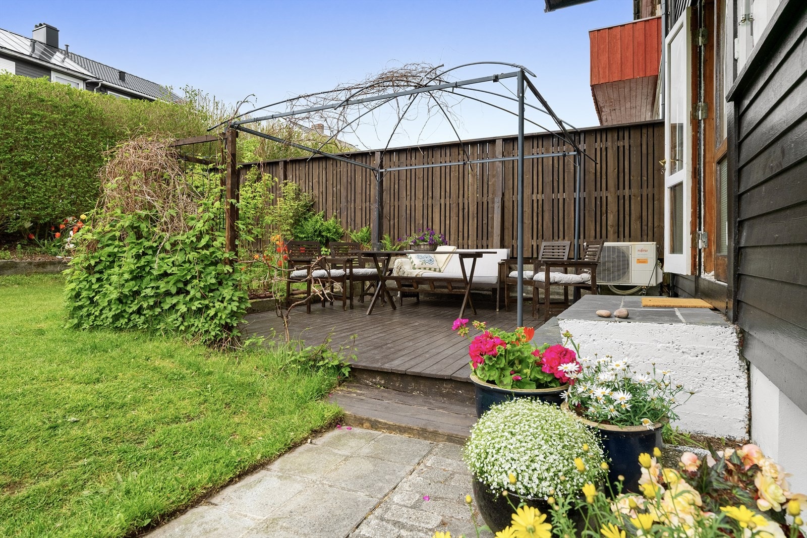 Hyggelig uteplass med terrasse og plen Galleribilde