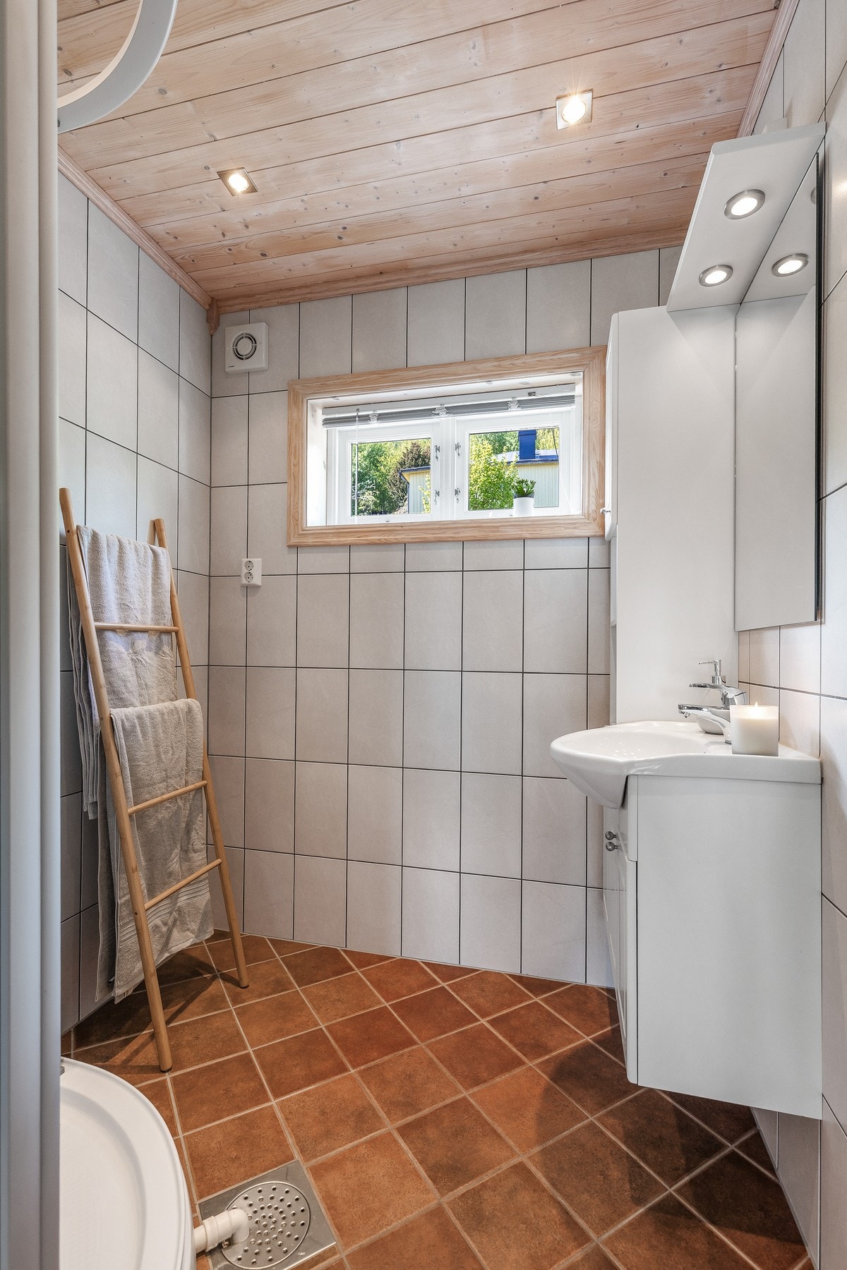 Bad fra byggeår med flislagt gulv med gulvvarme, flislagte vegger og panelbord i himling Galleribilde
