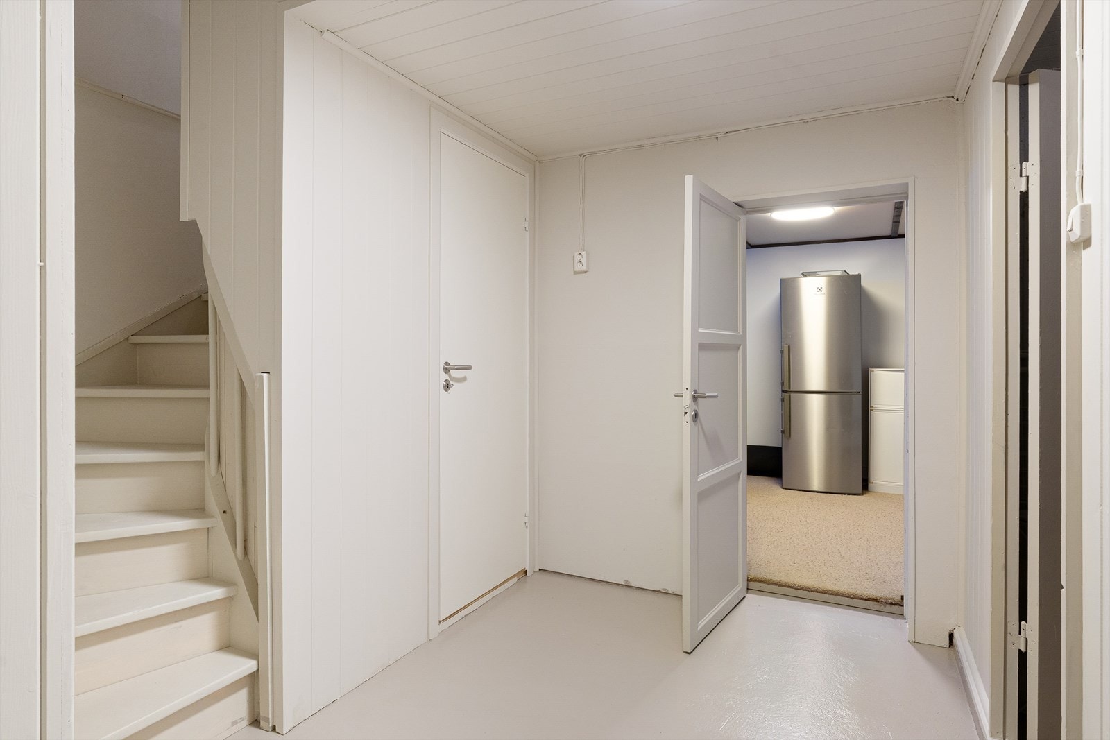Fra gangen i kjelleren er det tilgang til boder, vaskerom og et innredet rom. Galleribilde
