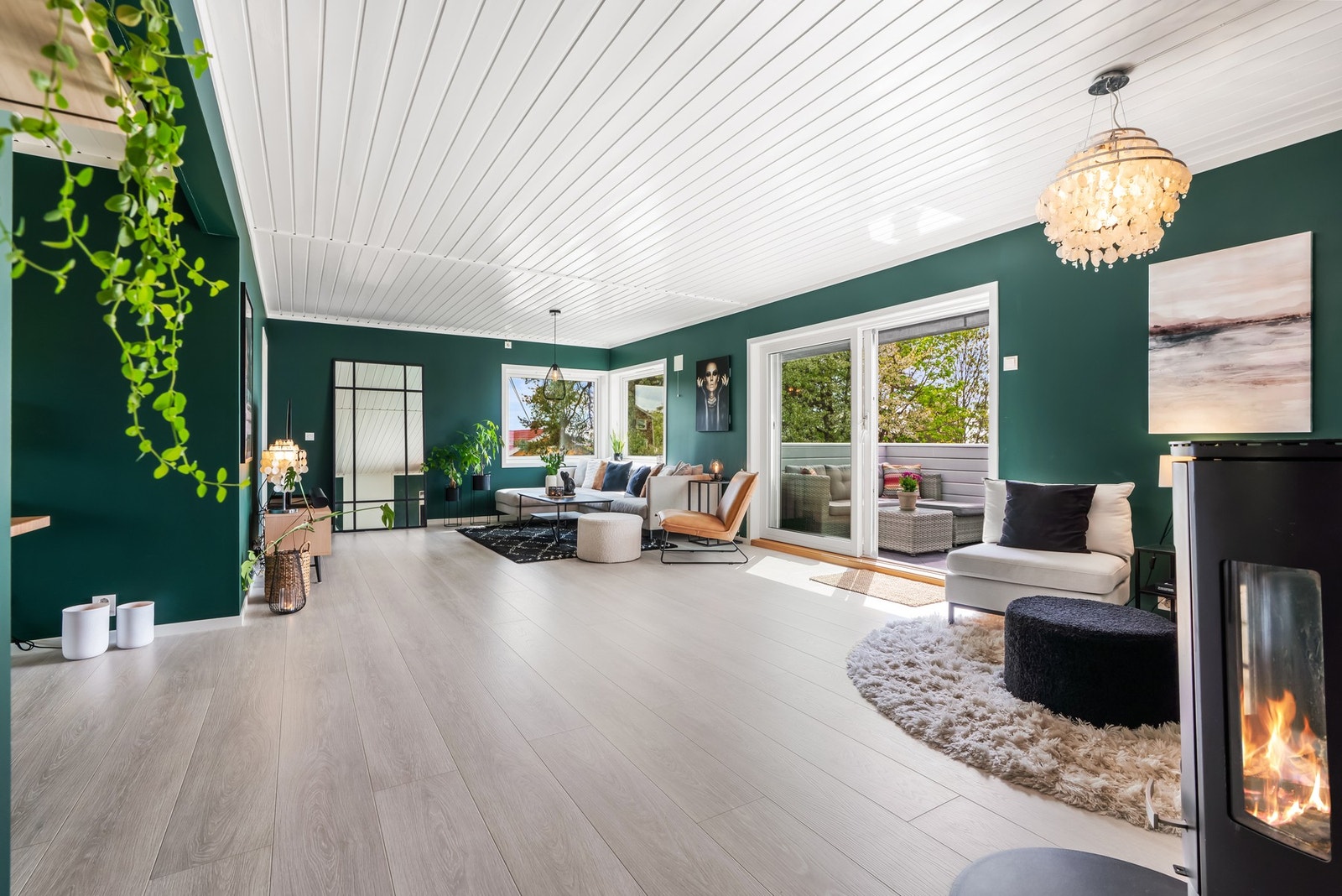 Stuen er malt i en moderne tone, kombinert med hvitmalt panelhimling og pent laminatgulv i enstavs design. Galleribilde