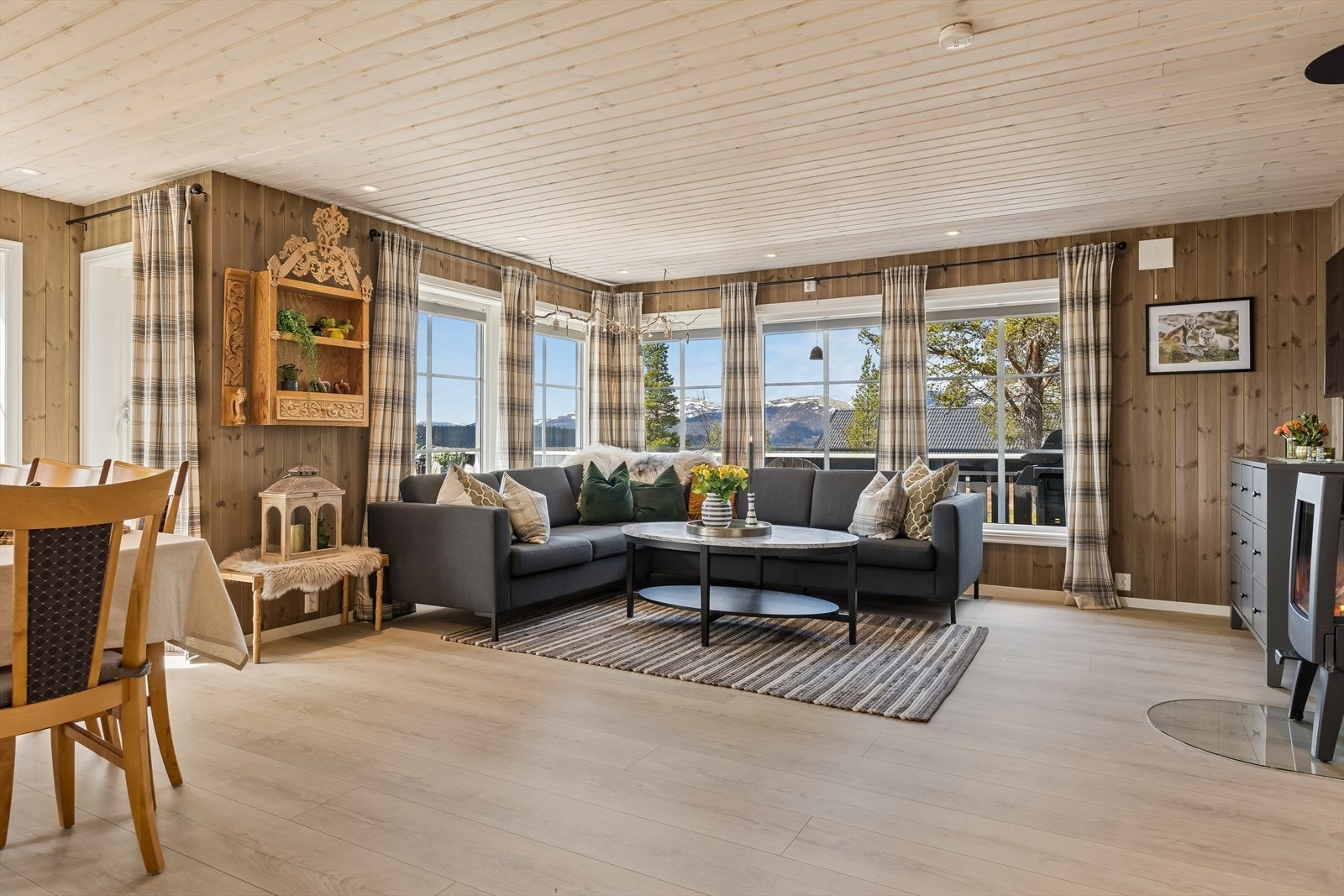 Stuen har god plass til sofagruppe og varmes effektivt av en sentralt plassert vedovn med isolert stålpipe. Galleribilde
