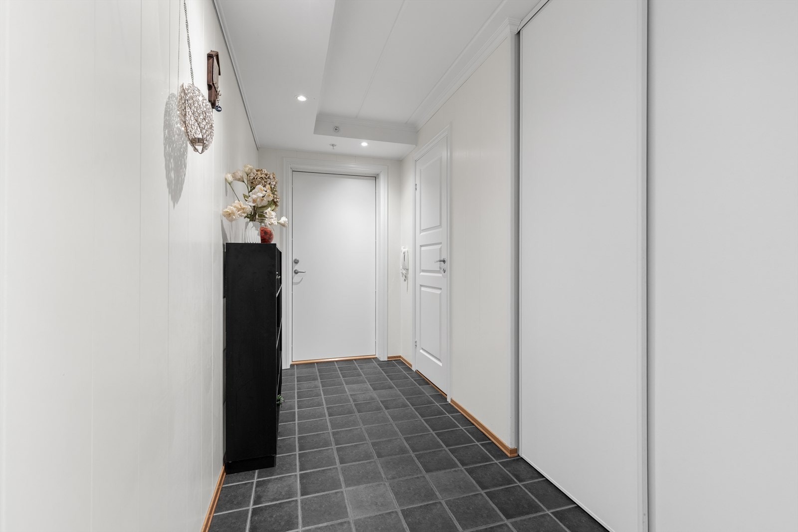Romslig entré med flislagt gulv og plass til garderobeløsninger. Galleribilde