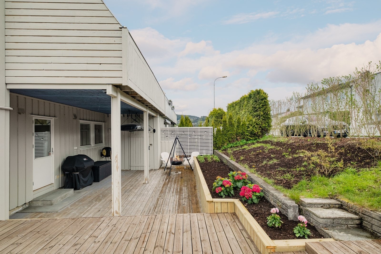 Terrassen nede er skjermet og pent anlagt i flere nivåer. Det er også en utvendig bod. Galleribilde