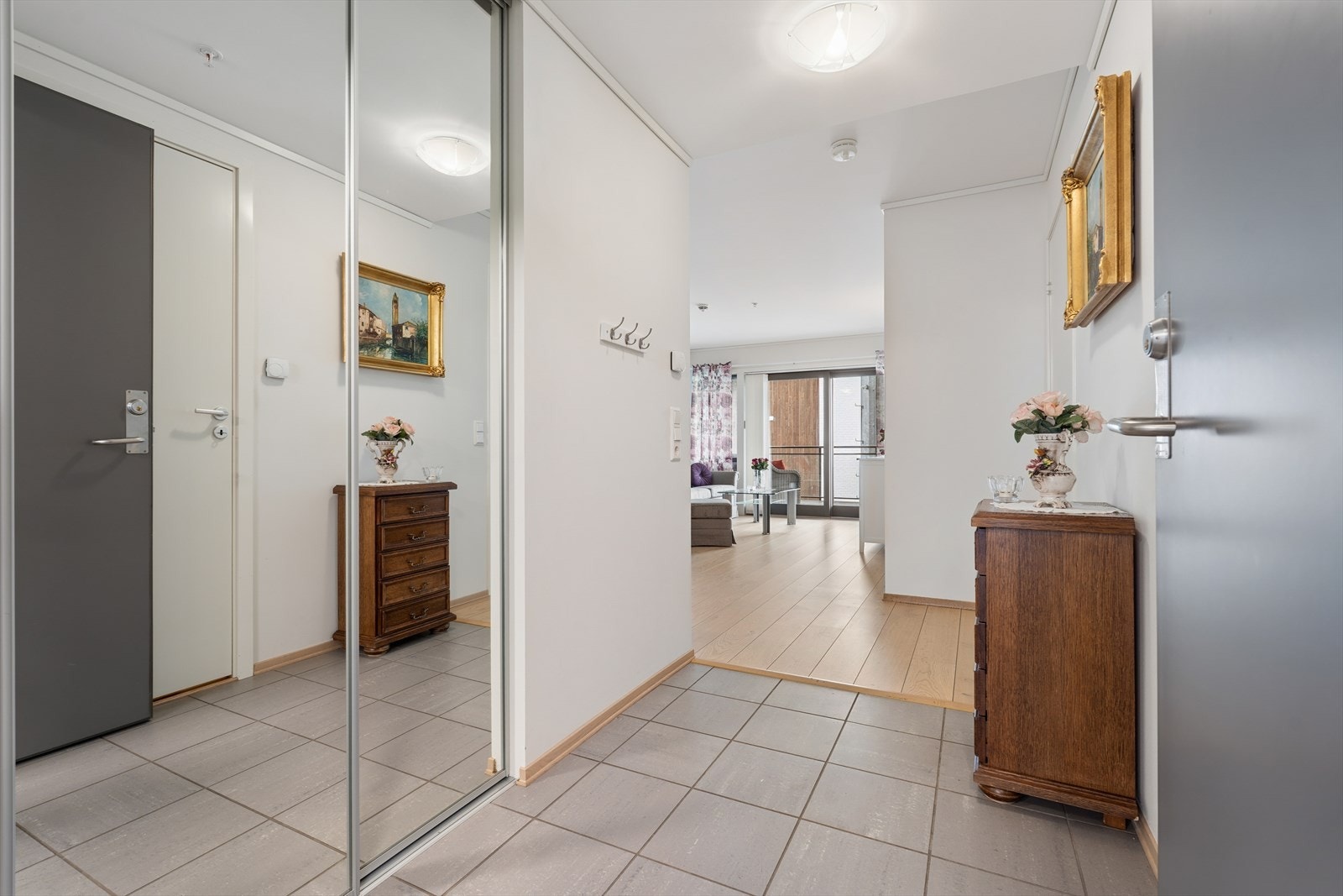 Entré med flislagt gulv og en romslig skyvedørsgarderobe for praktisk oppbevaring. Galleribilde