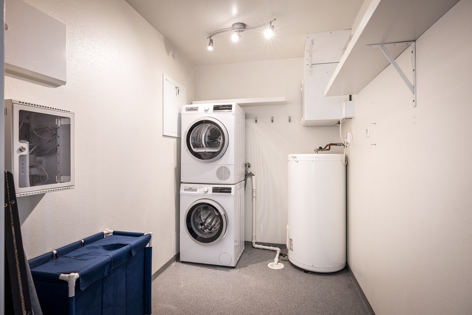 Vegg i vegg med badet ligger et praktisk vaskerom/bod med opplegg for vaskemaskin og plass til tørketrommel. Galleribilde