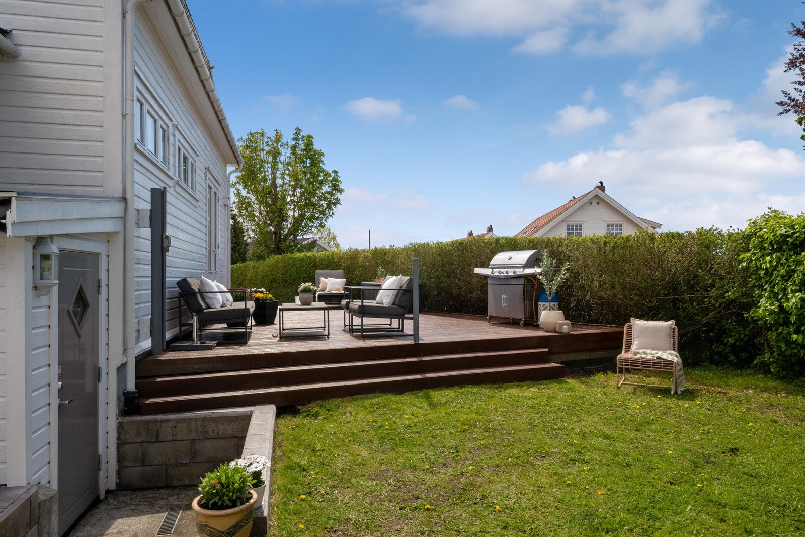 Overgangen mellom terrasse og uteområde gir eiendommen en åpen og innbydende følelse, perfekt for rolige morgener og lange sommerkvelder ute. Galleribilde