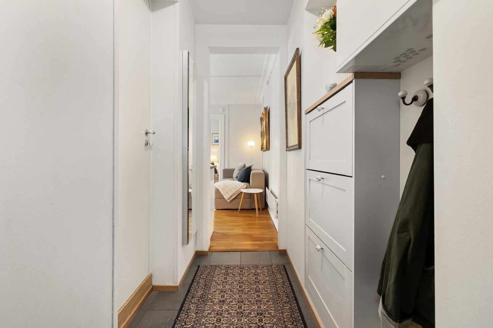 Innbydende entré med plass til oppheng av yttertøy og sko. Galleribilde