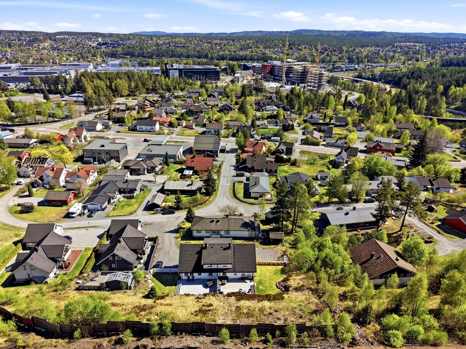 Oversikt over nabolaget, som hovedsakelig består av eneboliger. På baksiden av eiendommen er det også satt opp en solid støyskjerm mot toglinja. Galleribilde