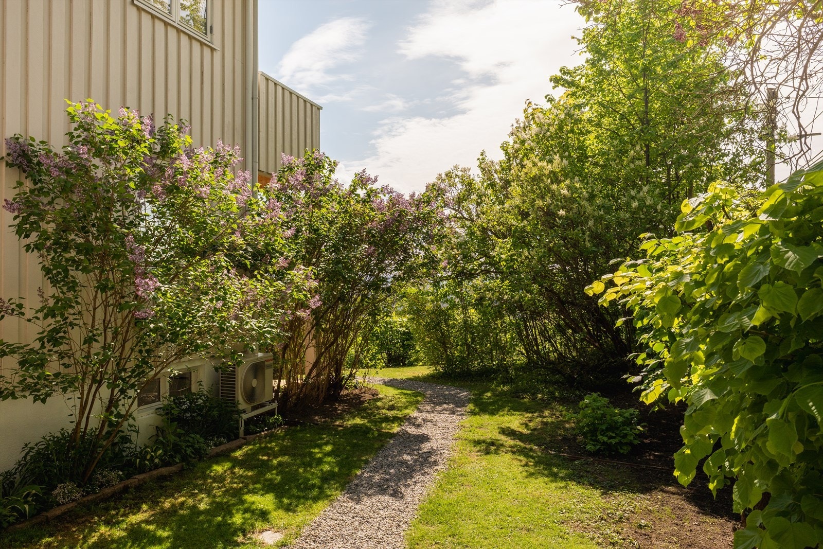 Frodig hage med vakre beplantninger. Koselig grusvei til terrasse og utsiktspunkt. Galleribilde