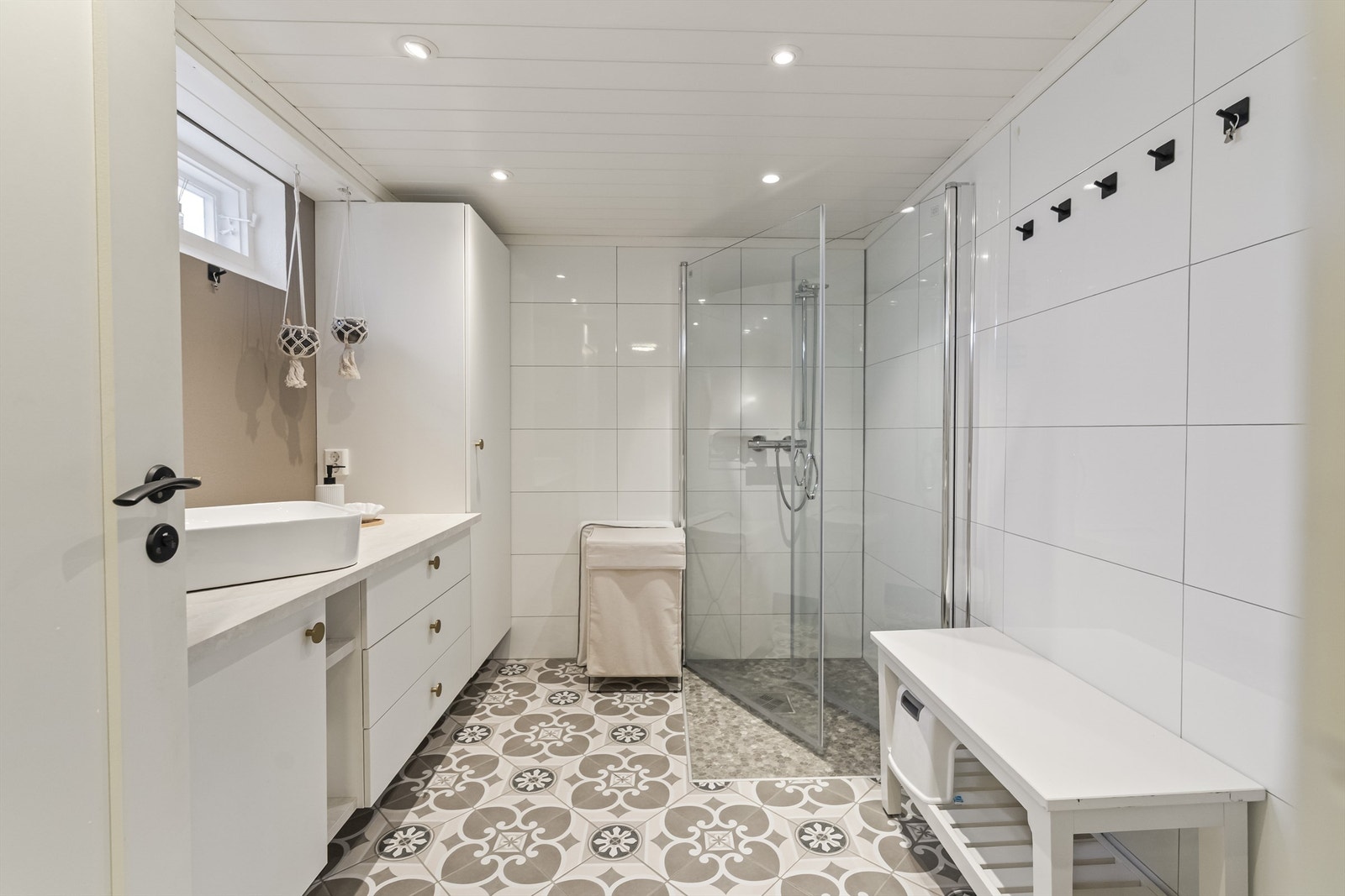 Badet i kjelleren har flislagt gulv med gulvvarme og innfelte downlights. Galleribilde