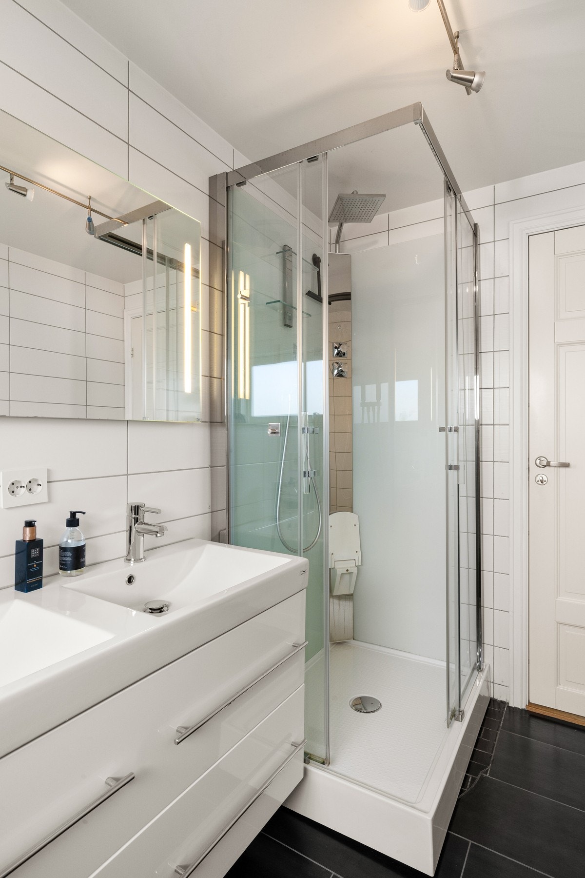 Badet er praktisk plassert i tilknytning til soveromsfløyen, og løsningen med dobbel servant gjør rommet godt egnet for en familiehverdag. Galleribilde