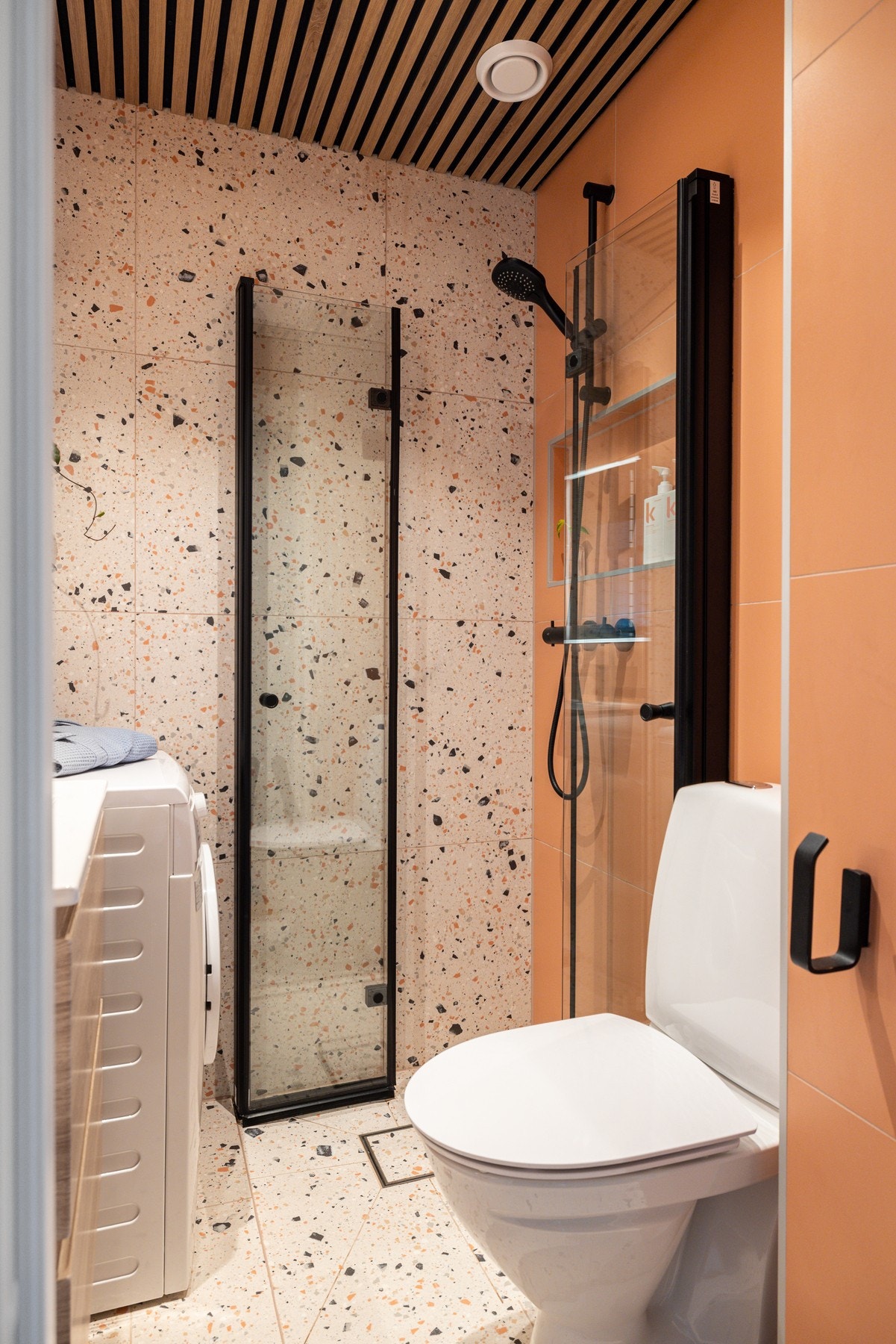 Lekre terrazzo fliser kombinert med sorte detaljer gir badet et eksklusivt preg. Galleribilde
