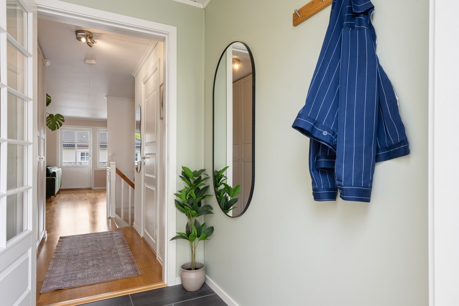 Her ønskes du velkommen inn i en flislagt entré med plass til å henge fra seg ytterklær. Galleribilde