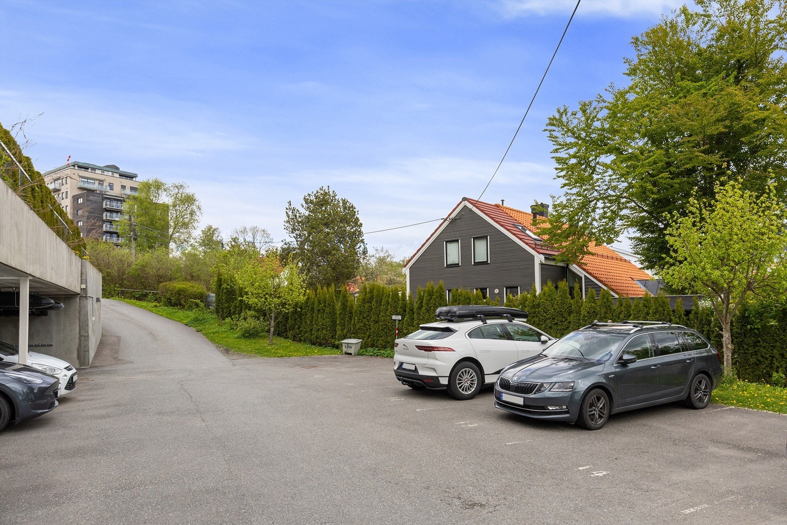 Det medfølger en parkeringsplass med ladeboks i carport, samt en parkeringsplass under åpen himmel. Galleribilde