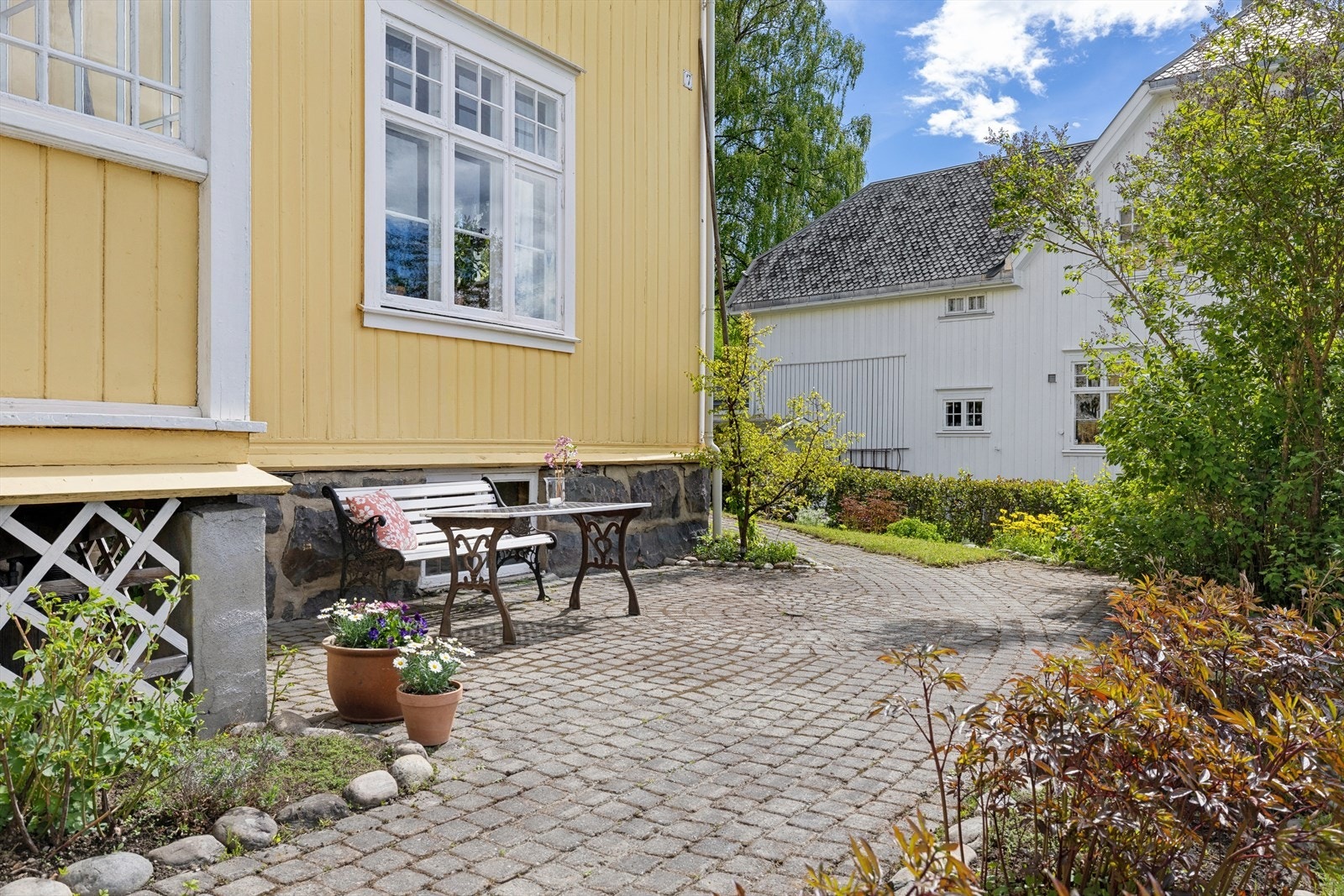 Det er en fin, steinlagt uteplass utenfor boligen mot vest. Galleribilde