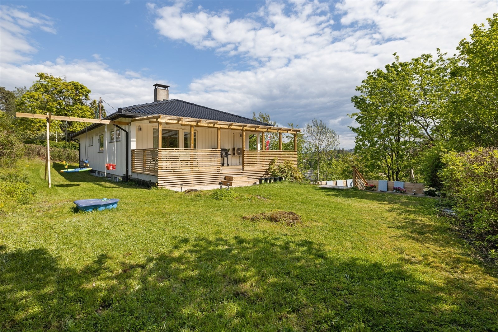 Boligen har en stor hage med gode solforhold gjennom hele dagen og flere fine soner for opphold og aktiviteter utendørs. Galleribilde