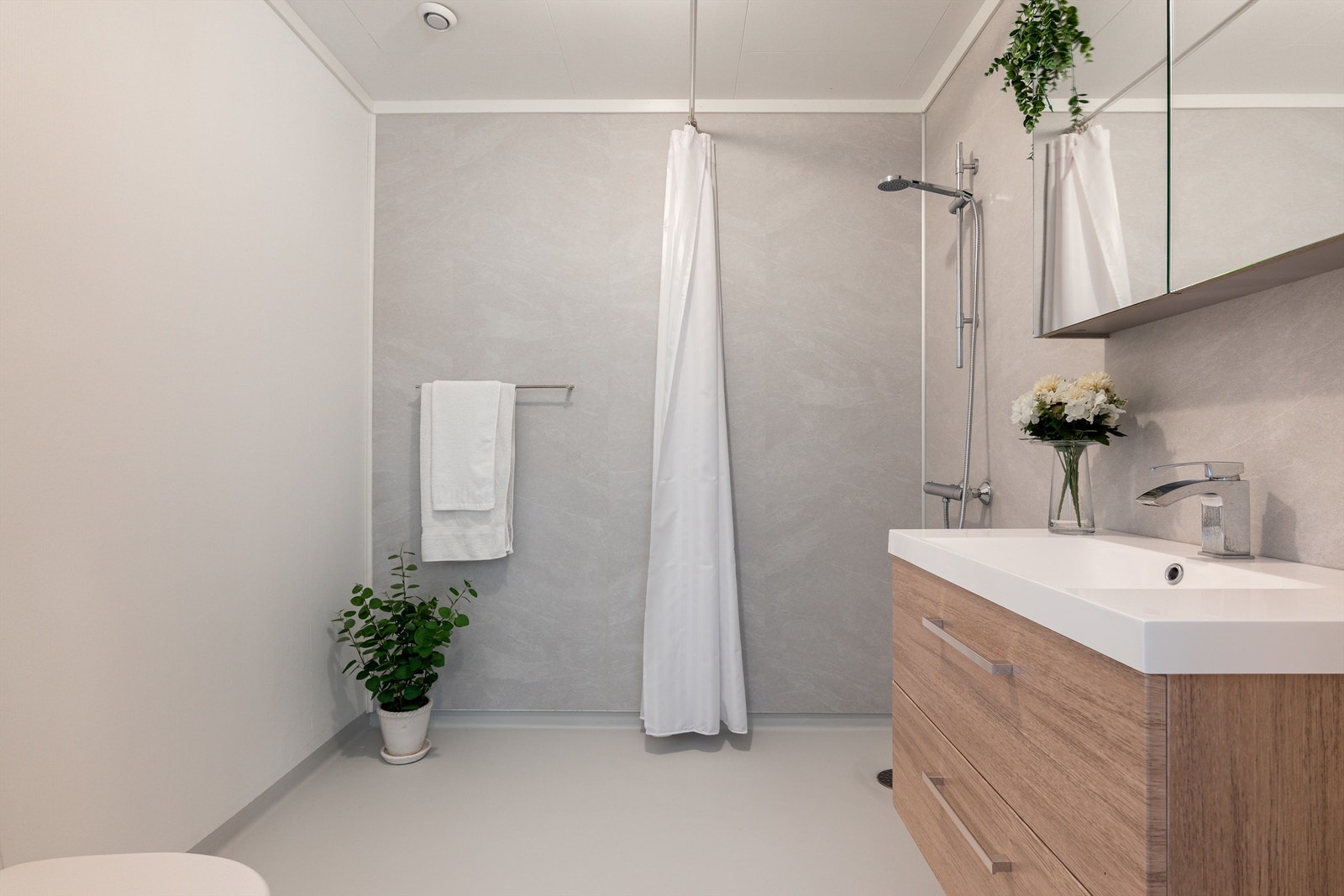 Velholdt bad med moderne innredning, dusjløsning og stilrene overflater. Galleribilde
