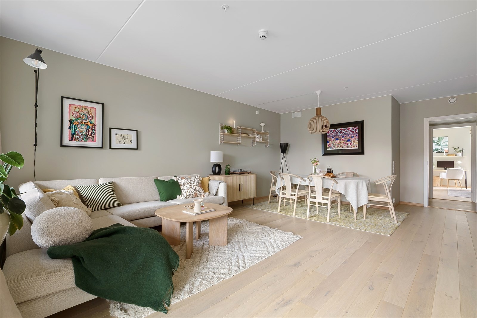 Lys og luftig stue hvor det er god plass til sofa, TV-møblement og spisebord Galleribilde