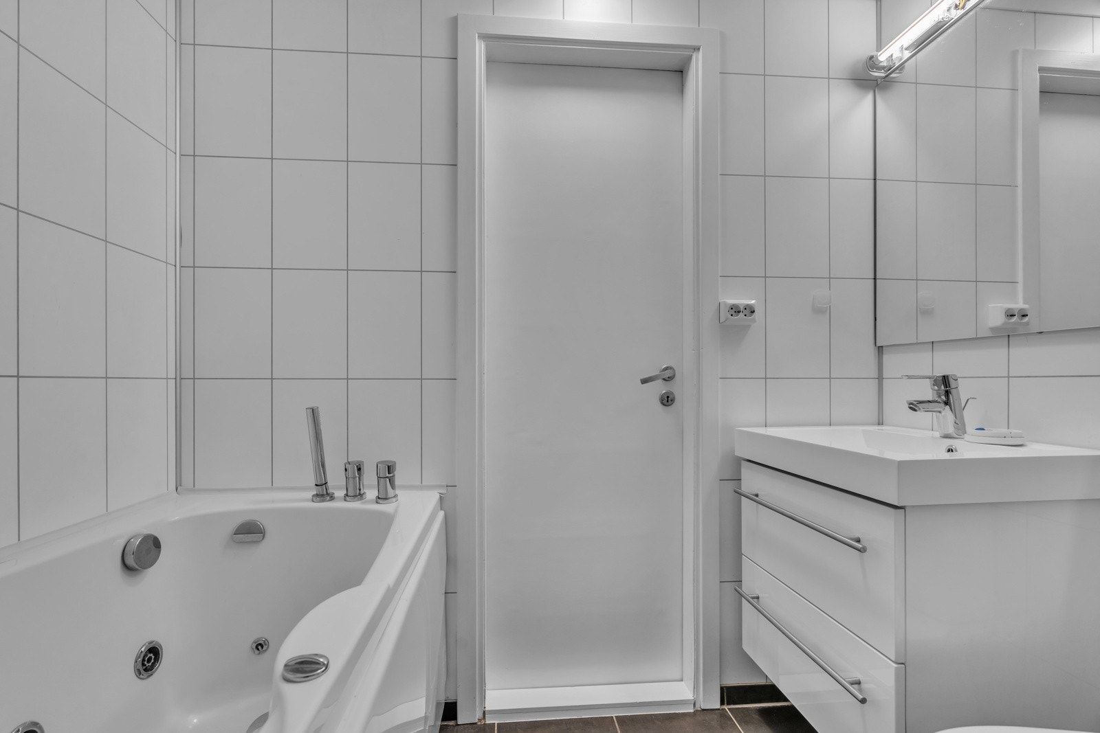 Fliselagt bad med varmekabler i gulv og boblekar. Galleribilde