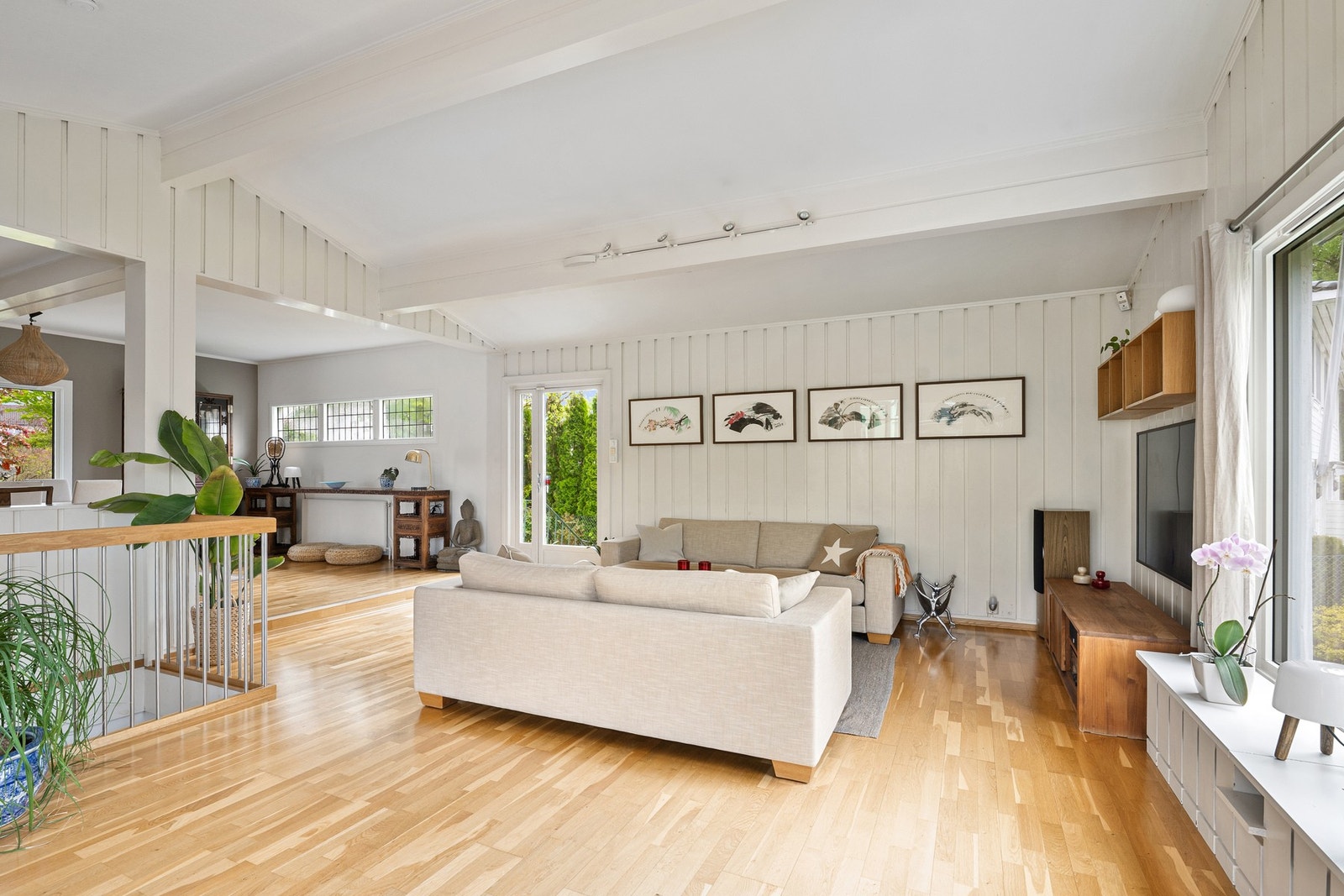 Stuen har god plass til flere soner og ligger i åpen forbindelse med spisestuen. Herfra er det også direkte utgang til hagen på baksiden av huset. Galleribilde