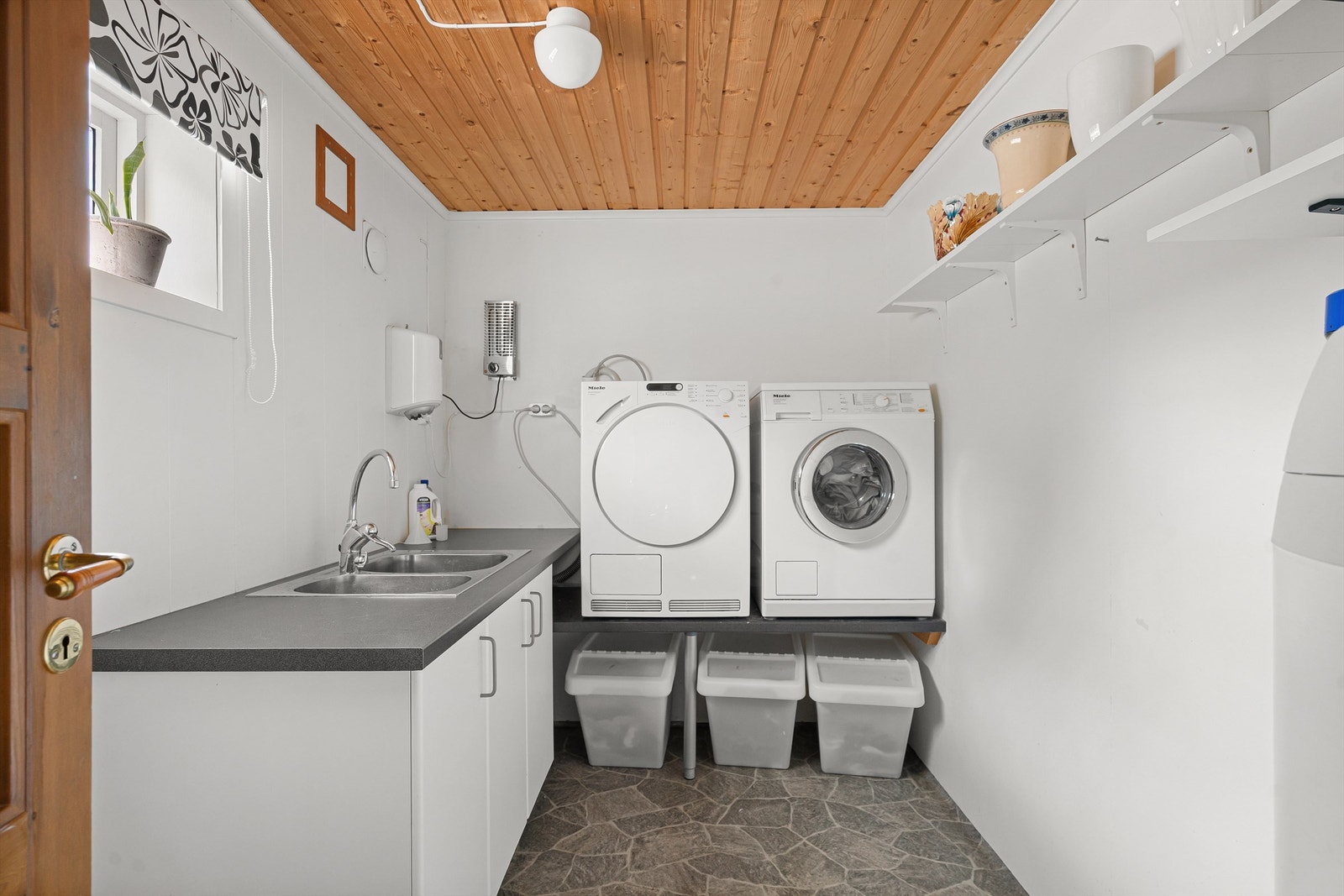 Praktisk vaskerom med opplegg for vaskemaskin og en 200-liters varmtvannsbereder fra 2009. Galleribilde