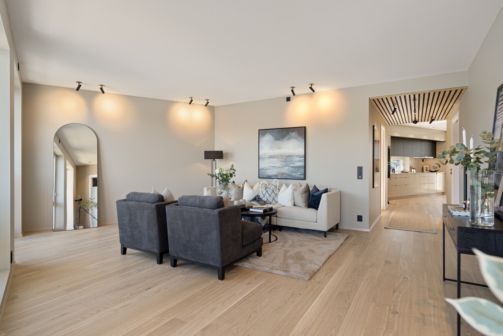 Rommet har god plass til både sofagruppe og en hyggelig sosial sone, og den åpne utformingen gir fleksible møbleringsmuligheter. Lyse overflater og en rolig fargepalett bidrar til et stilrent og behagelig uttrykk. Galleribilde