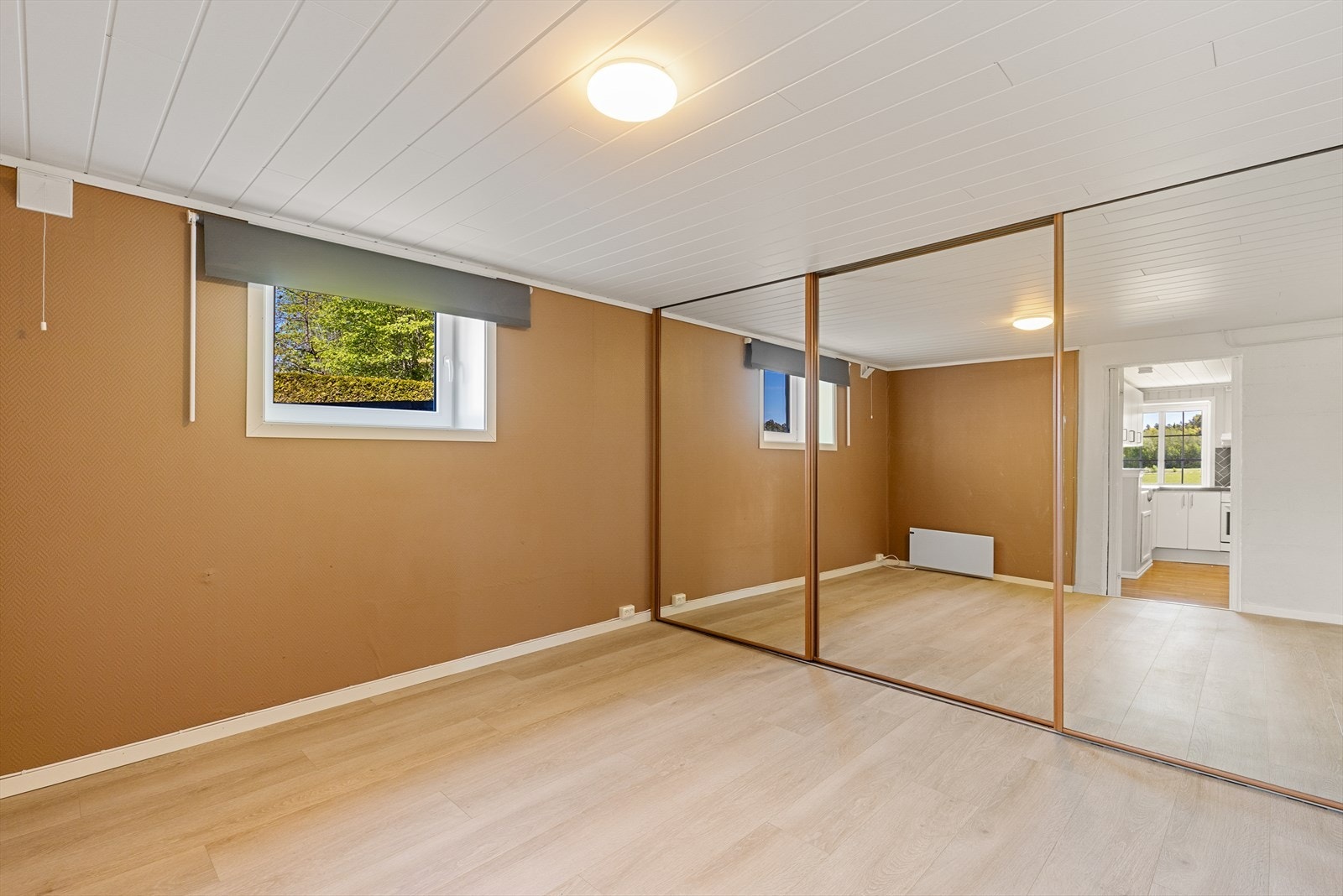 Soverom med praktisk skyvedørsgarderobe. Nytt gulv, ny panelovn og nytt, større rømningsvindu montert i 2021. Galleribilde