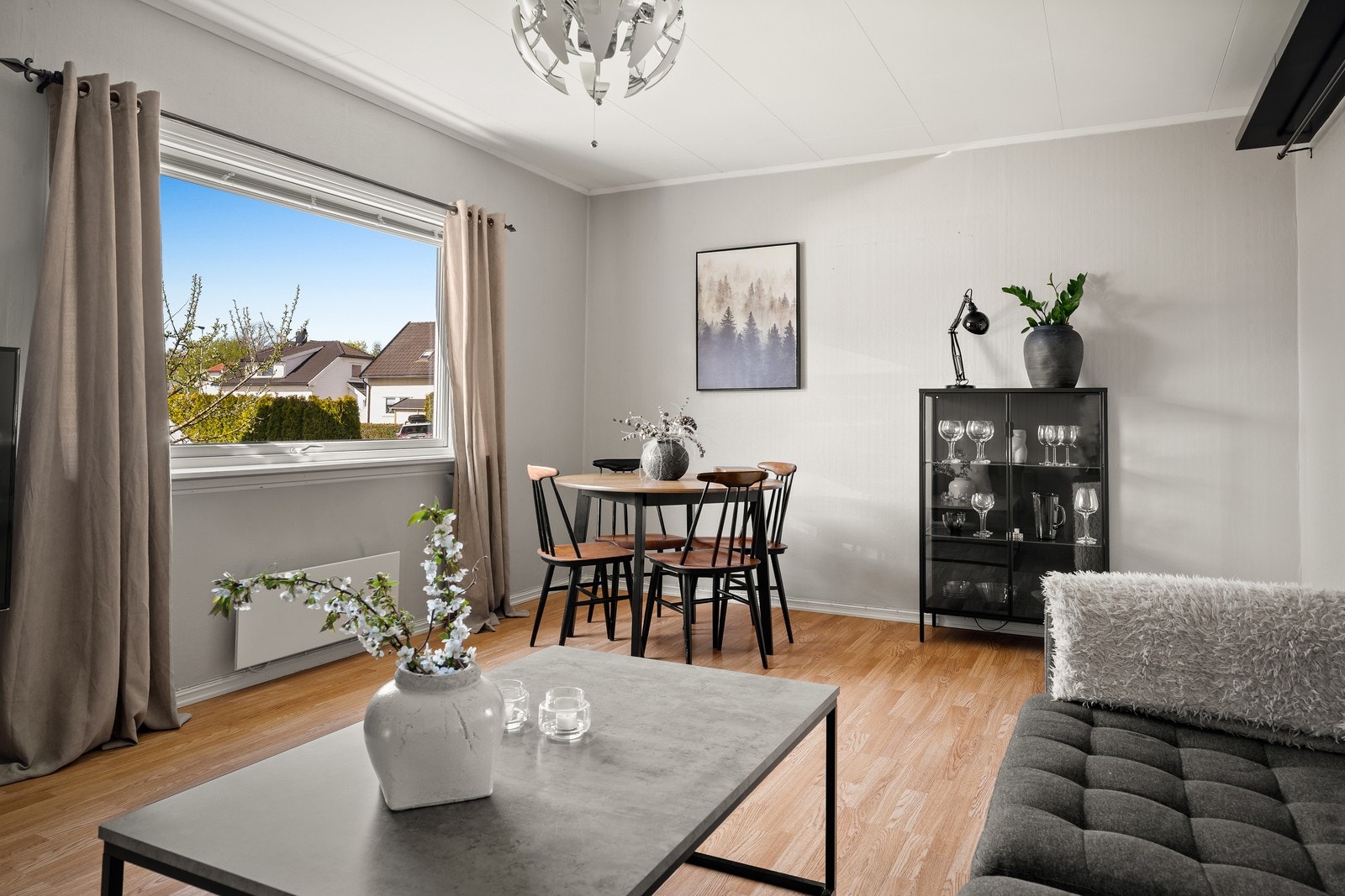 Stuevinduet vender ut mot den frodige hagen og slipper inn rikelig med naturlig lys, noe som gir rommet en lys og trivelig karakter gjennom hele dagen. Galleribilde