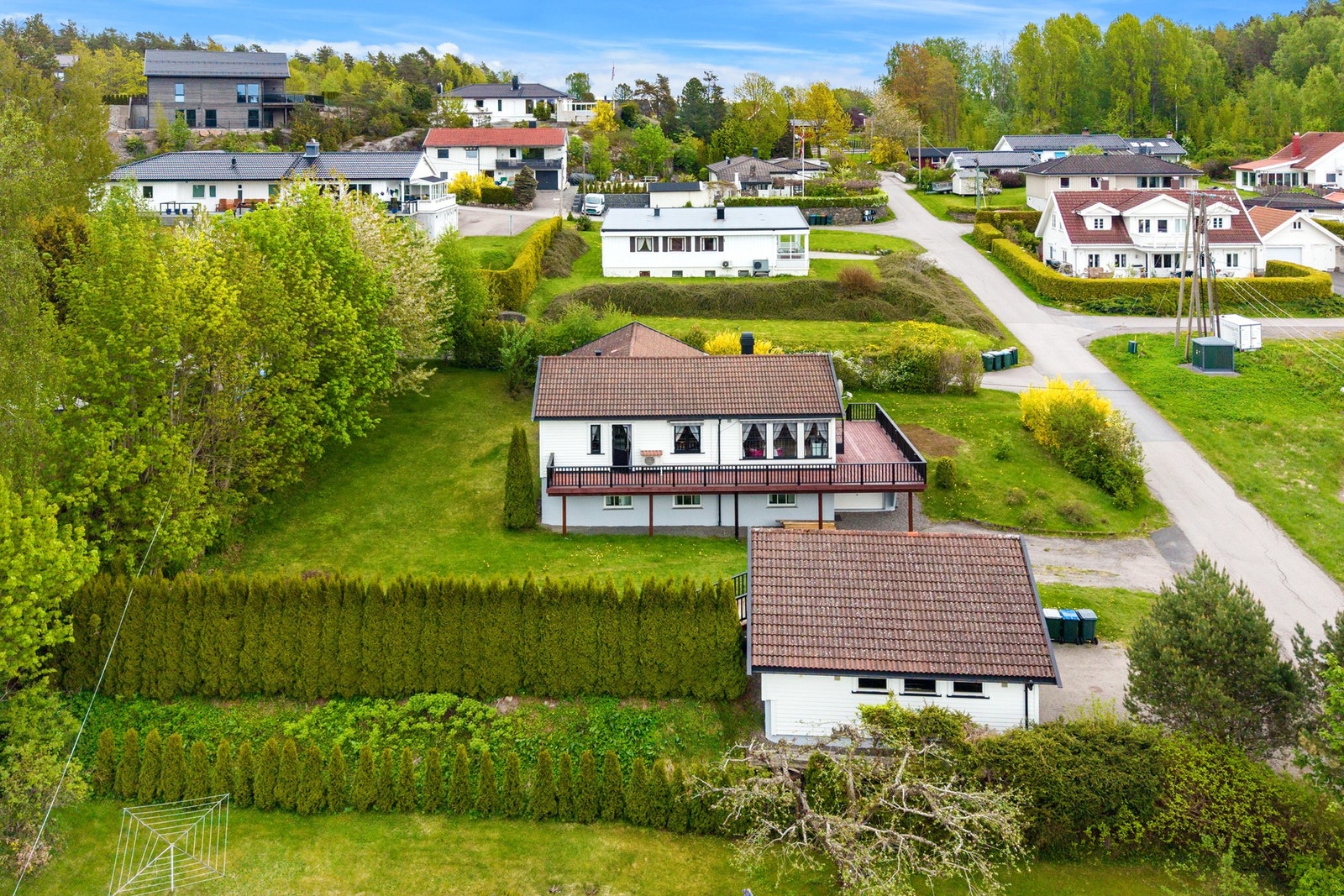 Boligen har en romslig terrasse med gode solforhold og utsikt over den frodige tomten. Galleribilde