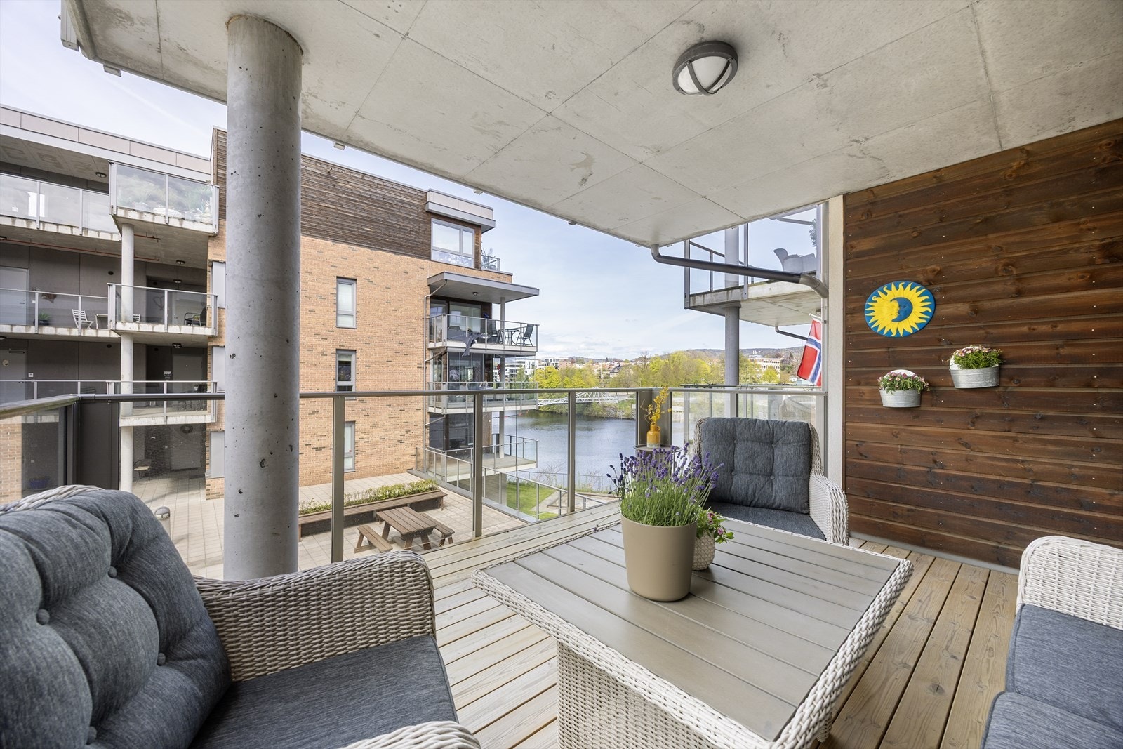 Boligen har en flott og overbygget veranda på 13 m² med god plass til sittegruppe og fin utsikt mot fellesarealene og vannet. Galleribilde