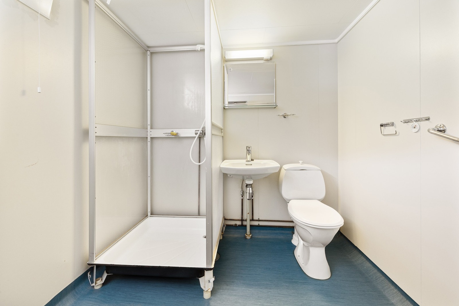 Bad i kjeller med toalett, servant og dusjkabinett. Galleribilde
