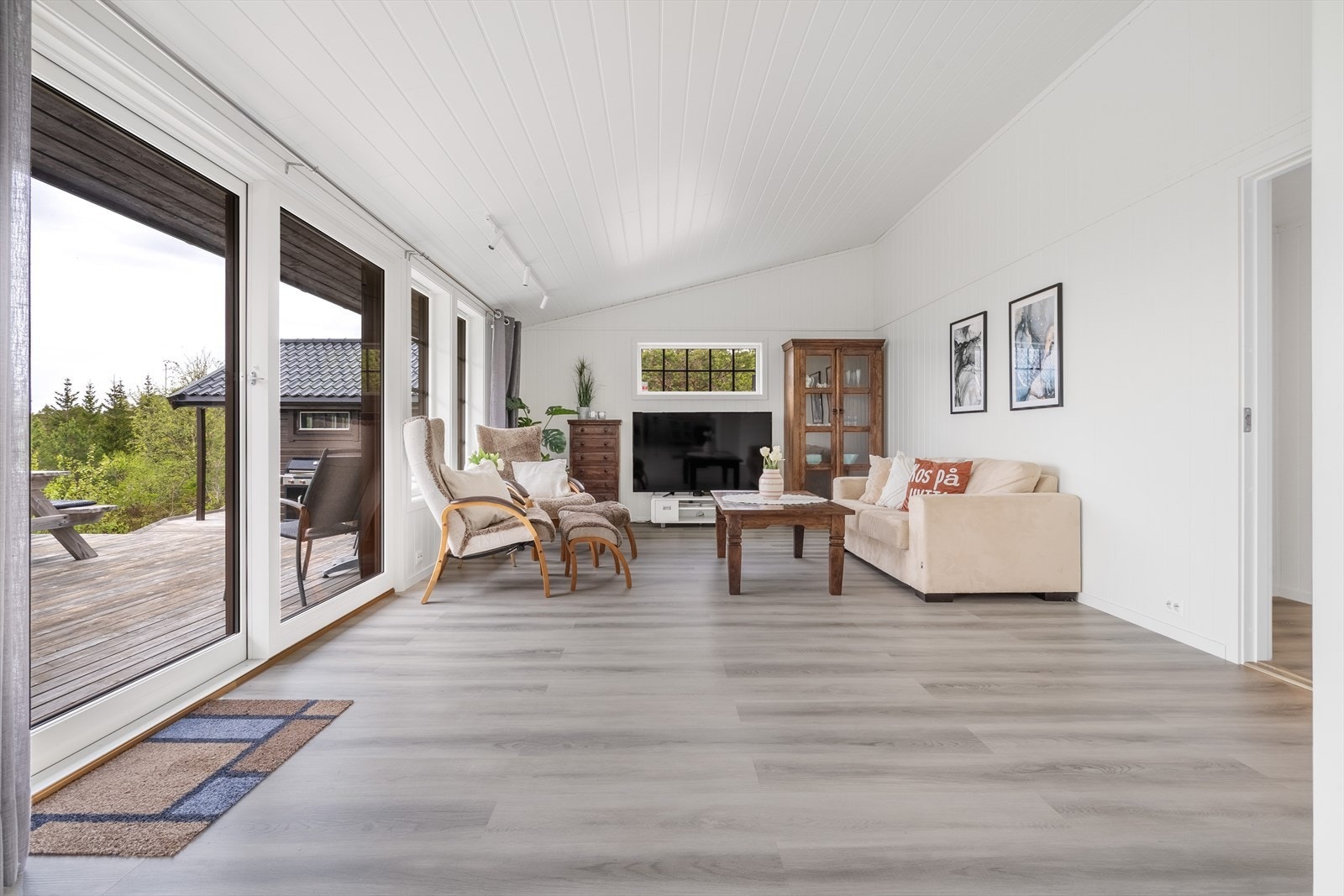 Stuen er romslig og lys med store vindusflater som slipper inn rikelig med naturlig lys. Galleribilde