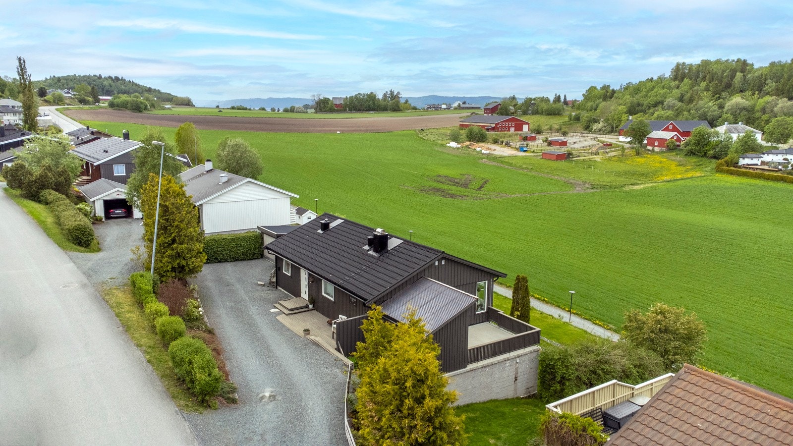 Gårdsplass med plass for flere biler. I tillegg har man garasje. Galleribilde