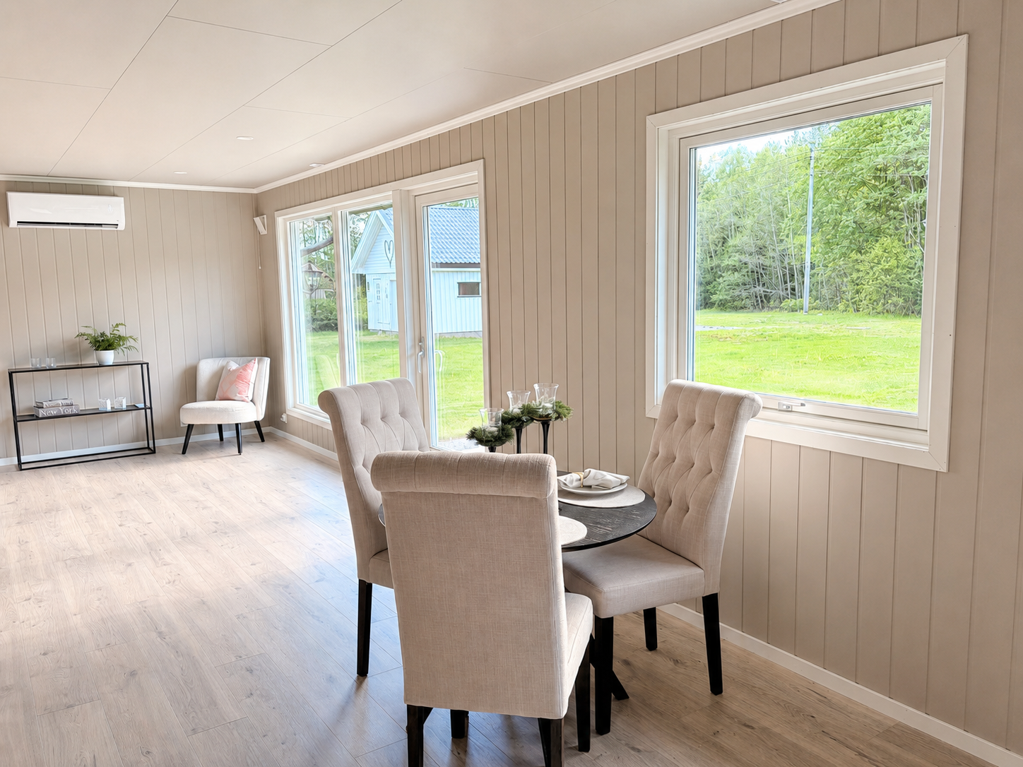 Stuen går i vinkel og har god plass til et større spisebord enn det som vises her. Galleribilde
