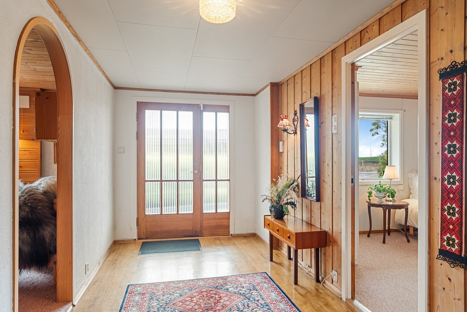 Stig på! Hovedytterdøren i teak åpner inn til en romslig entré/hall i underetasjen. Her er god plass til yttertøy og klær. Galleribilde