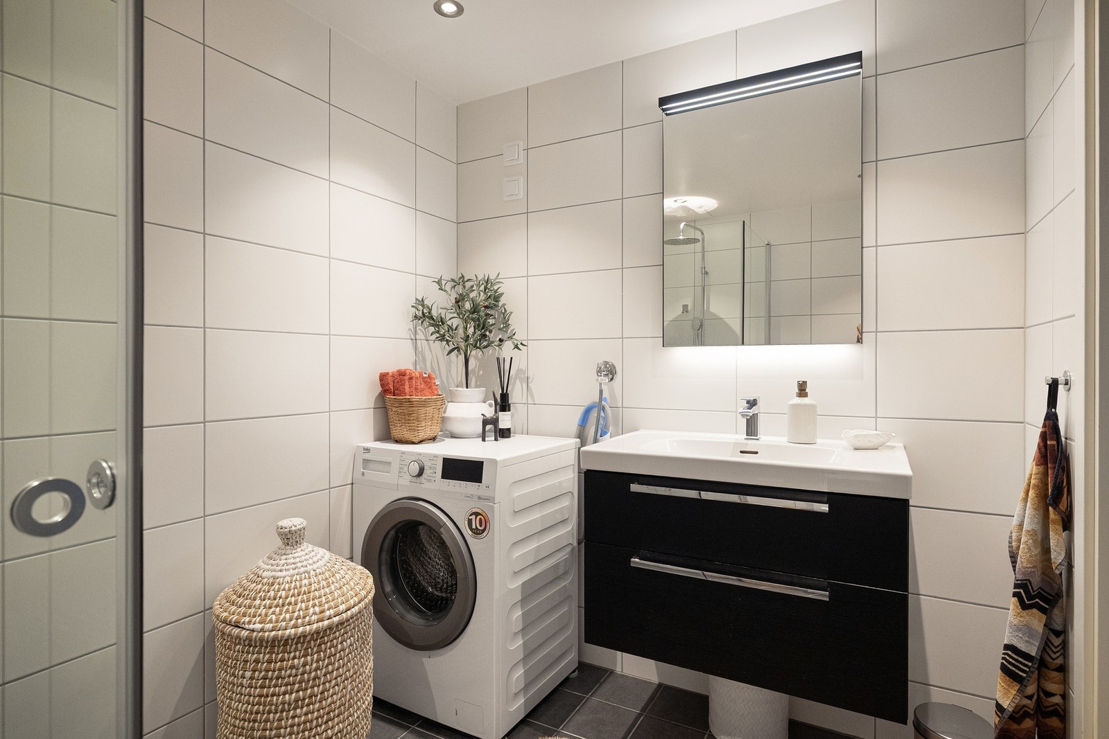 Badet har opplegg for vaskemaskin/tørketrommel, noe som bidrar til en funksjonell og komplett baderomsløsning. Galleribilde