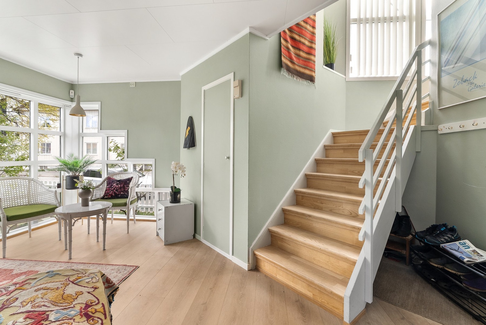 Romslig hall i første etasje med trapp opp til hoveddelen i andre etasje. Galleribilde