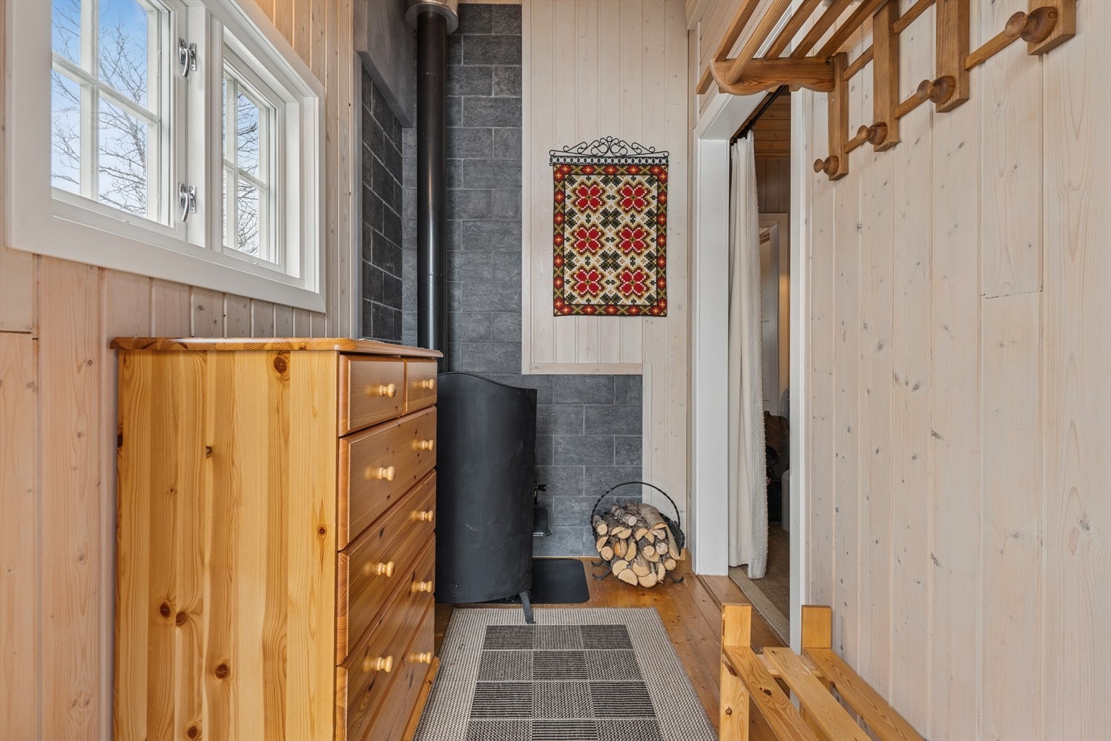 Entre/vindfang med vedovn og ny stålpipe. Galleribilde