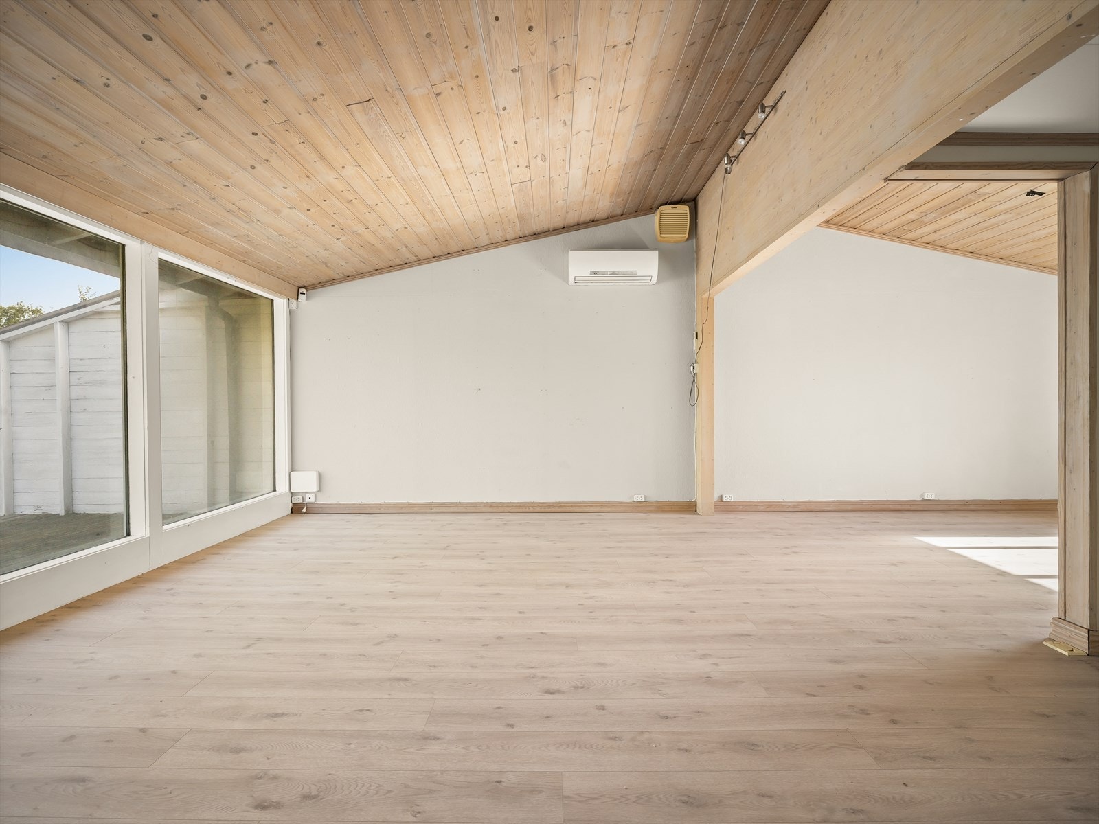 Store vindusflater og panel i taket preger oppholdsrommet. Galleribilde