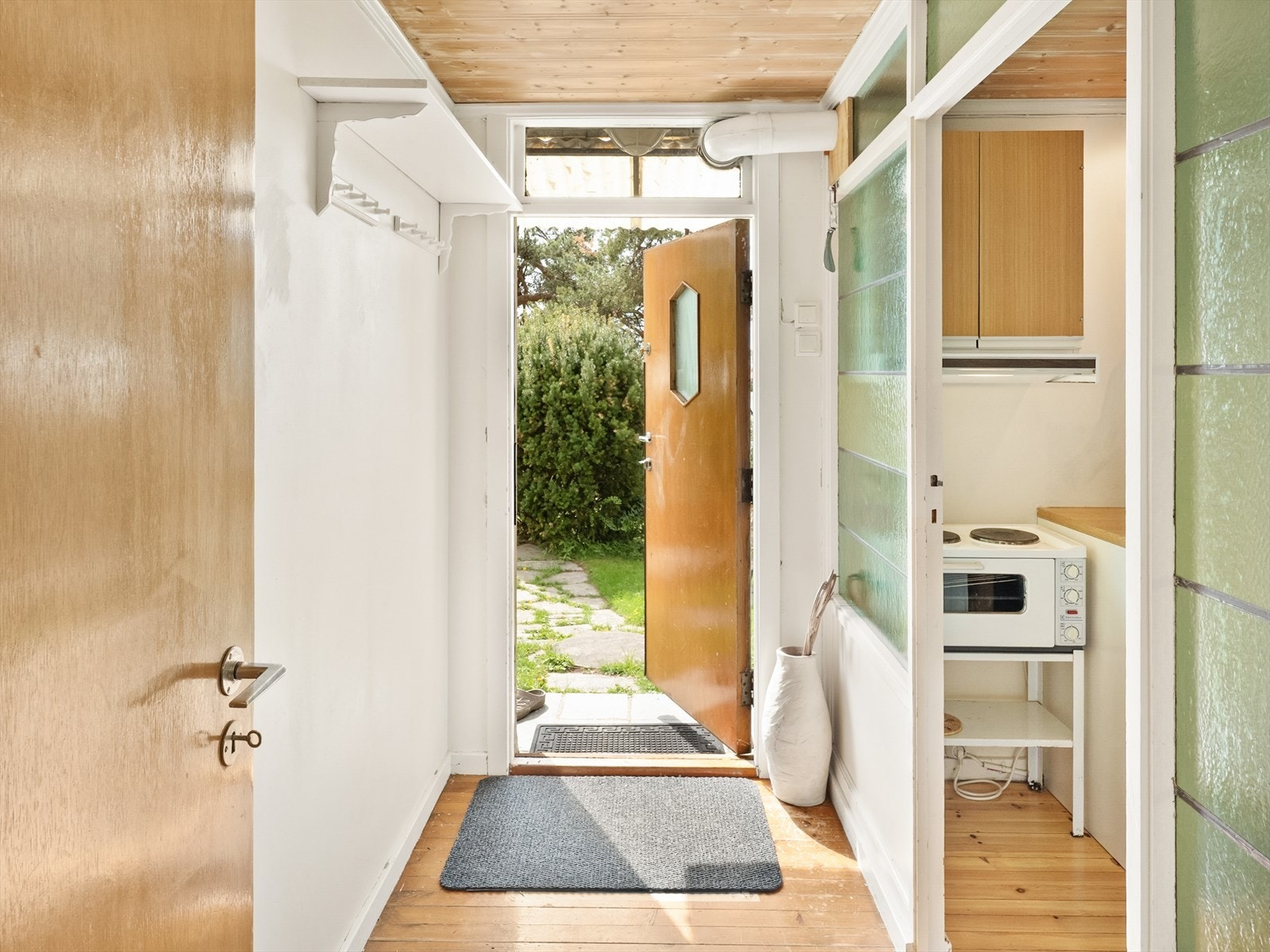 Entréen i kjelleren med lys glassvegg inn til stue/kjøkken delen. Galleribilde