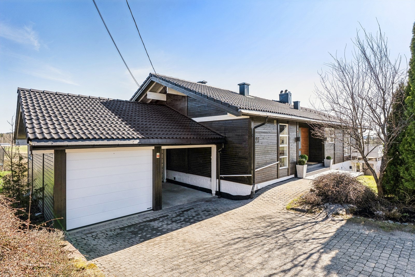 Det er parkering i garasje med elbillader, carport eller egen gårdsplass med plass til 2 biler Galleribilde