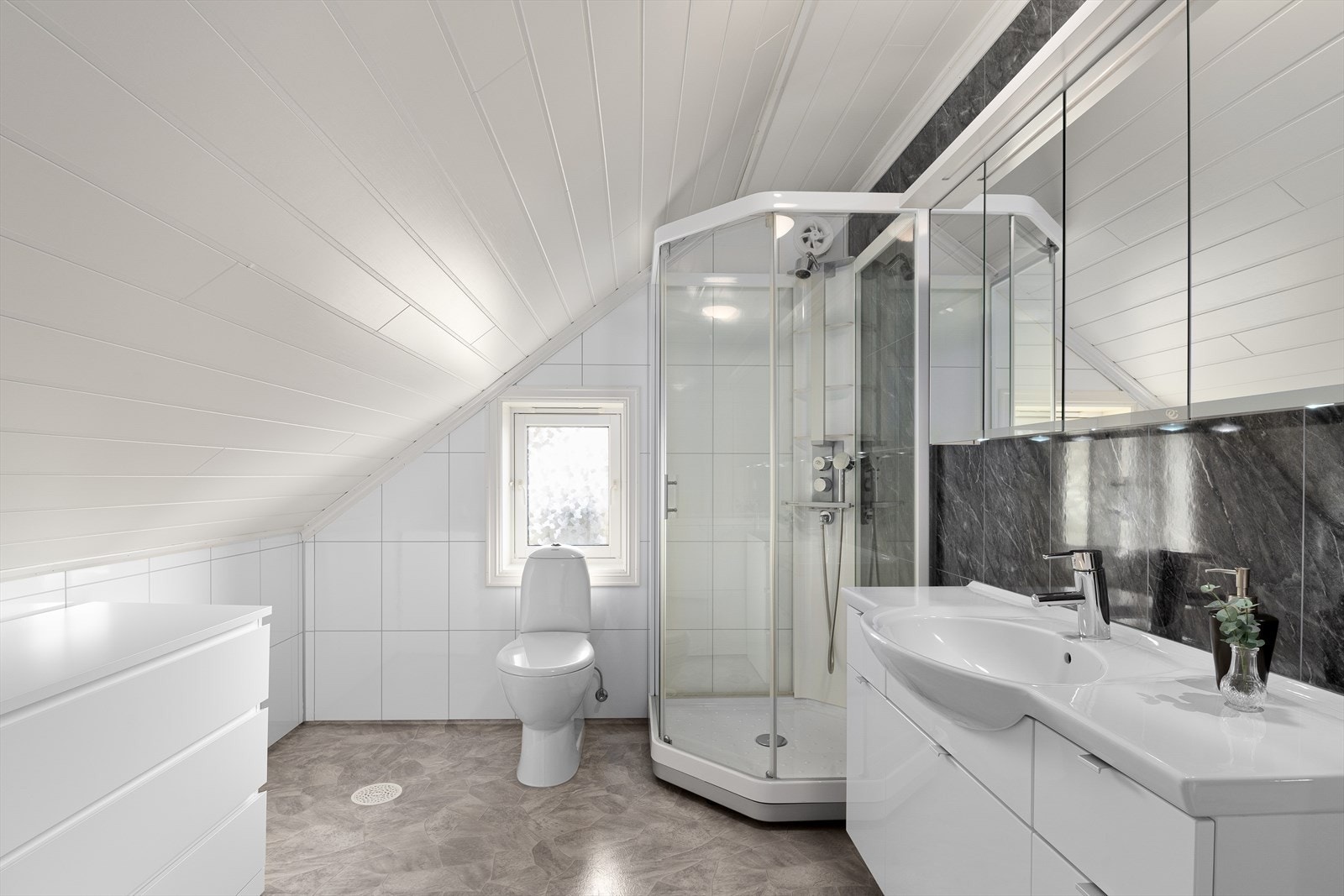 Badet på loftet er fra 2011 og er innredet med dusjkabinett, toalett og baderomsmøbel med vask. Galleribilde