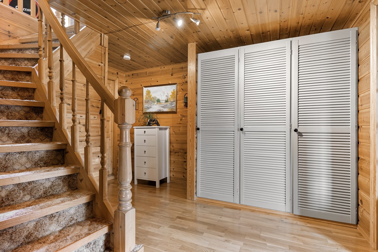 Gangen har god plass til oppbevaring og en trapp med teppebelagte trinn som leder opp til loftsetasjen. Galleribilde