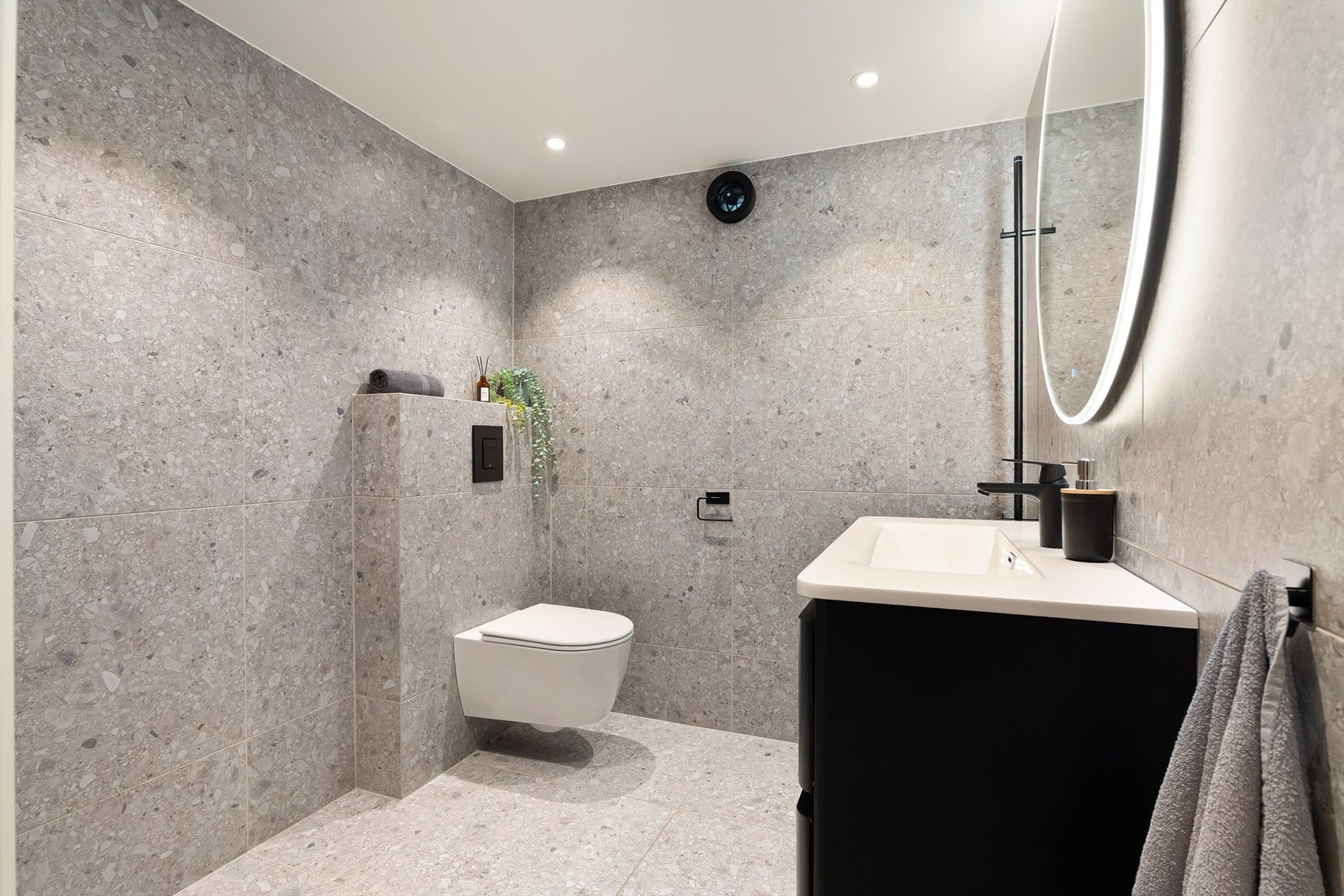 Badet pusset opp til moderne standard i 2022. I gulvet ble det lagt nye varmekabler. Terrazzo storformat fliser på gulv og vegger skaper helhet. Galleribilde