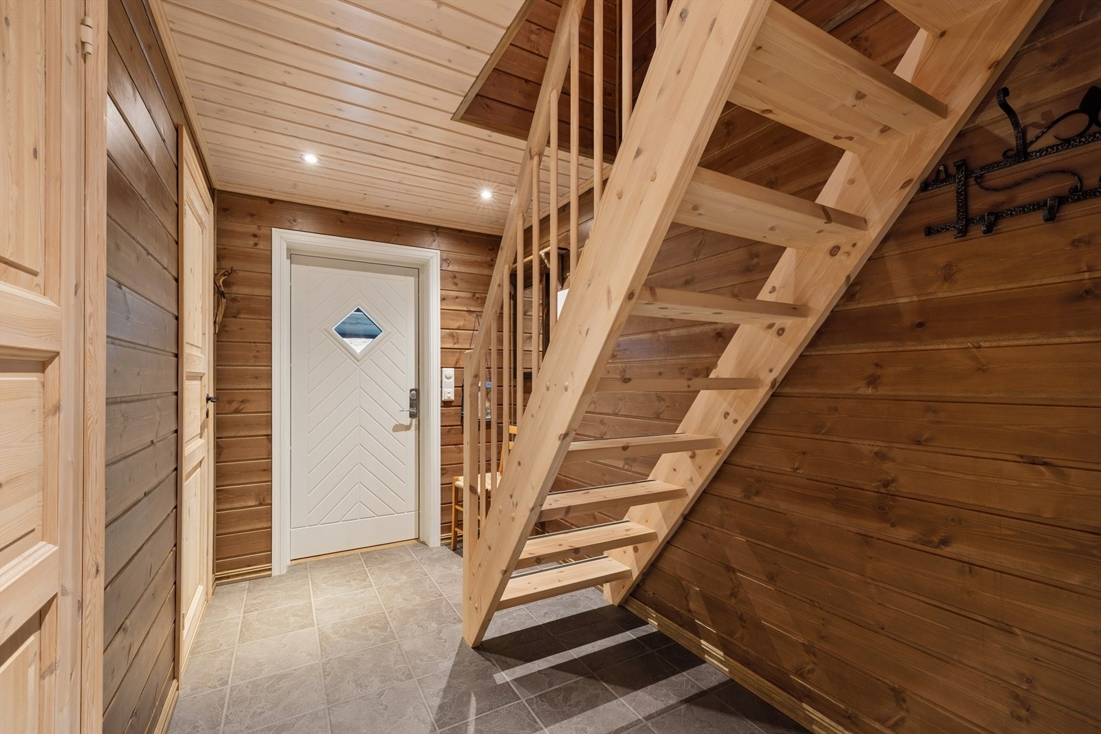 Gangen har flislagt gulv med elektrisk gulvvarme. Trappen fører opp til hemsen. Velkommen inn! Galleribilde