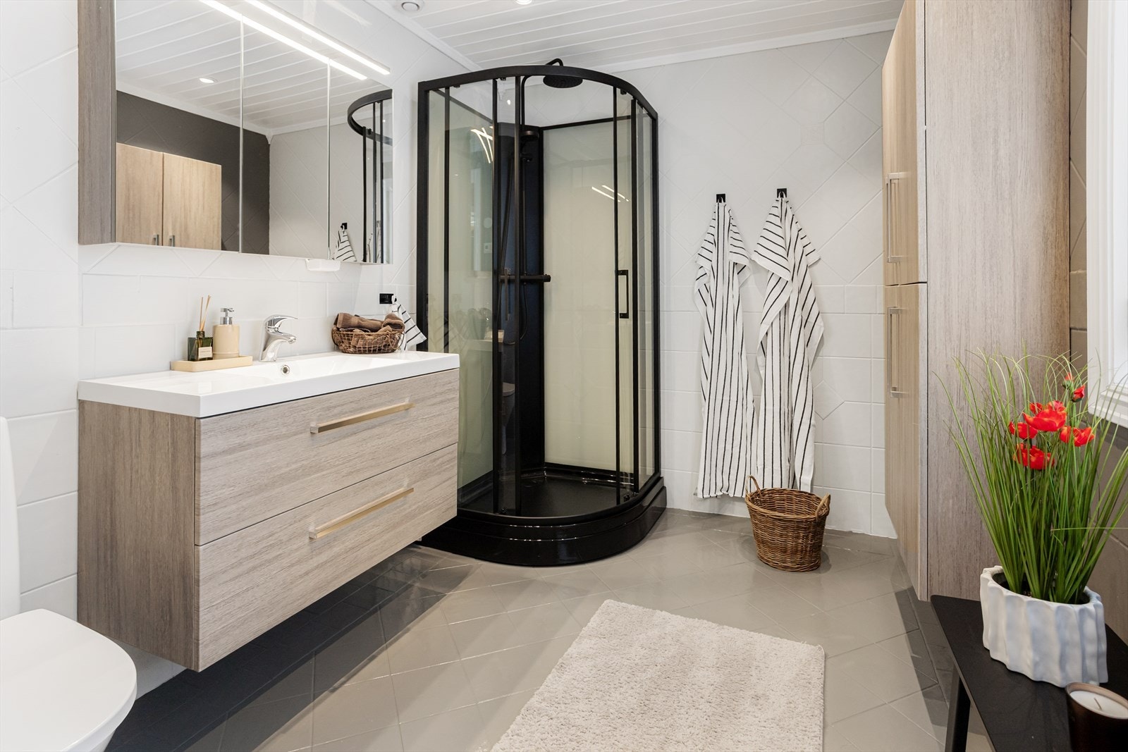 Badet i første etasje har flislagt gulv med elektrisk gulvvarme og dusjkabinett. Galleribilde