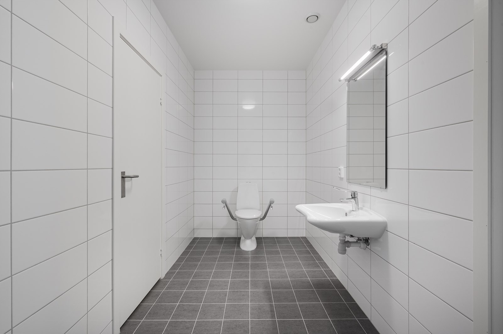 Badet er på 6,9 m² og har flislagte vegger og gulv samt malt tak. Galleribilde