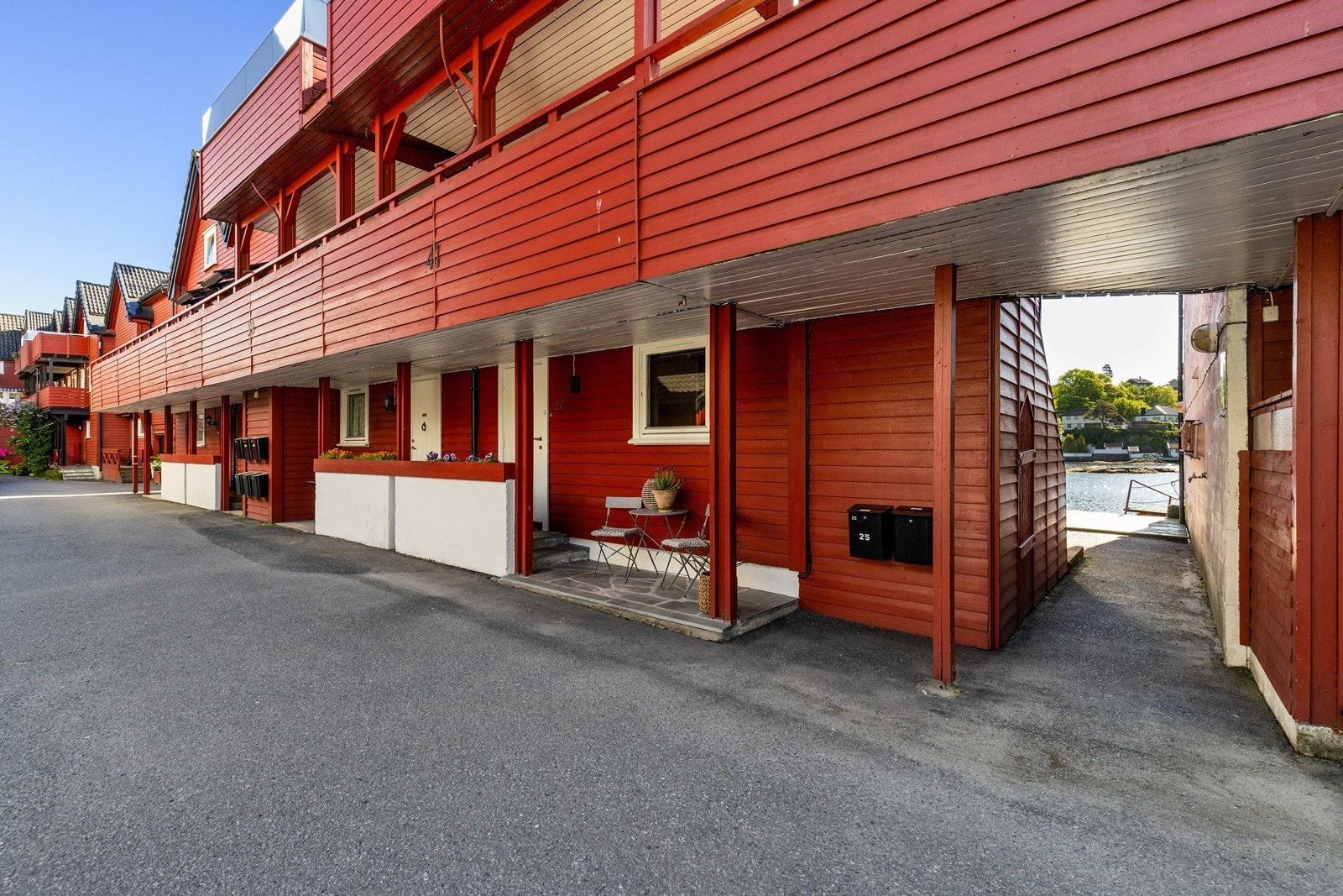 Fra uteplassen foran inngangspartiet kan du nyte kveldssolen og rolige omgivelser etter en lang dag. I mellomgangen ut mot bryggene har du felles utebod. Galleribilde