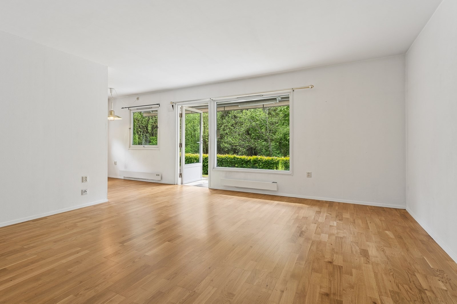 Lys stue med god plass til sofa og annet ønsket møblement. Store vindusflater slipper inn godt med naturlig lys. Galleribilde